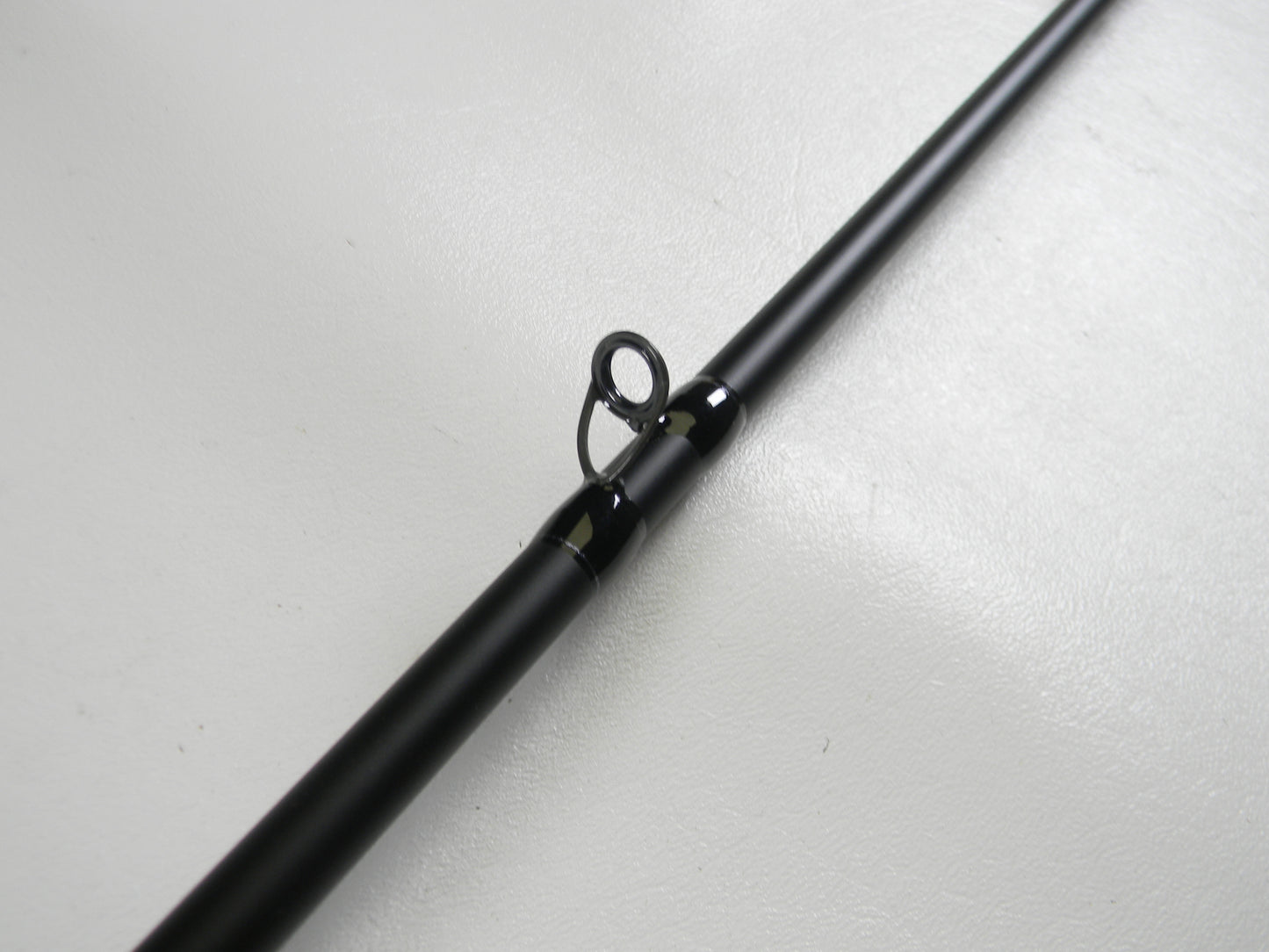 A close-up of the Dobyns Champion XP DC705C 7'0" Mag Heavy Used Casting Rod in excellent condition showcases its black finish and line guide, ideal for highlighting trade-in eligible gear for store credit.