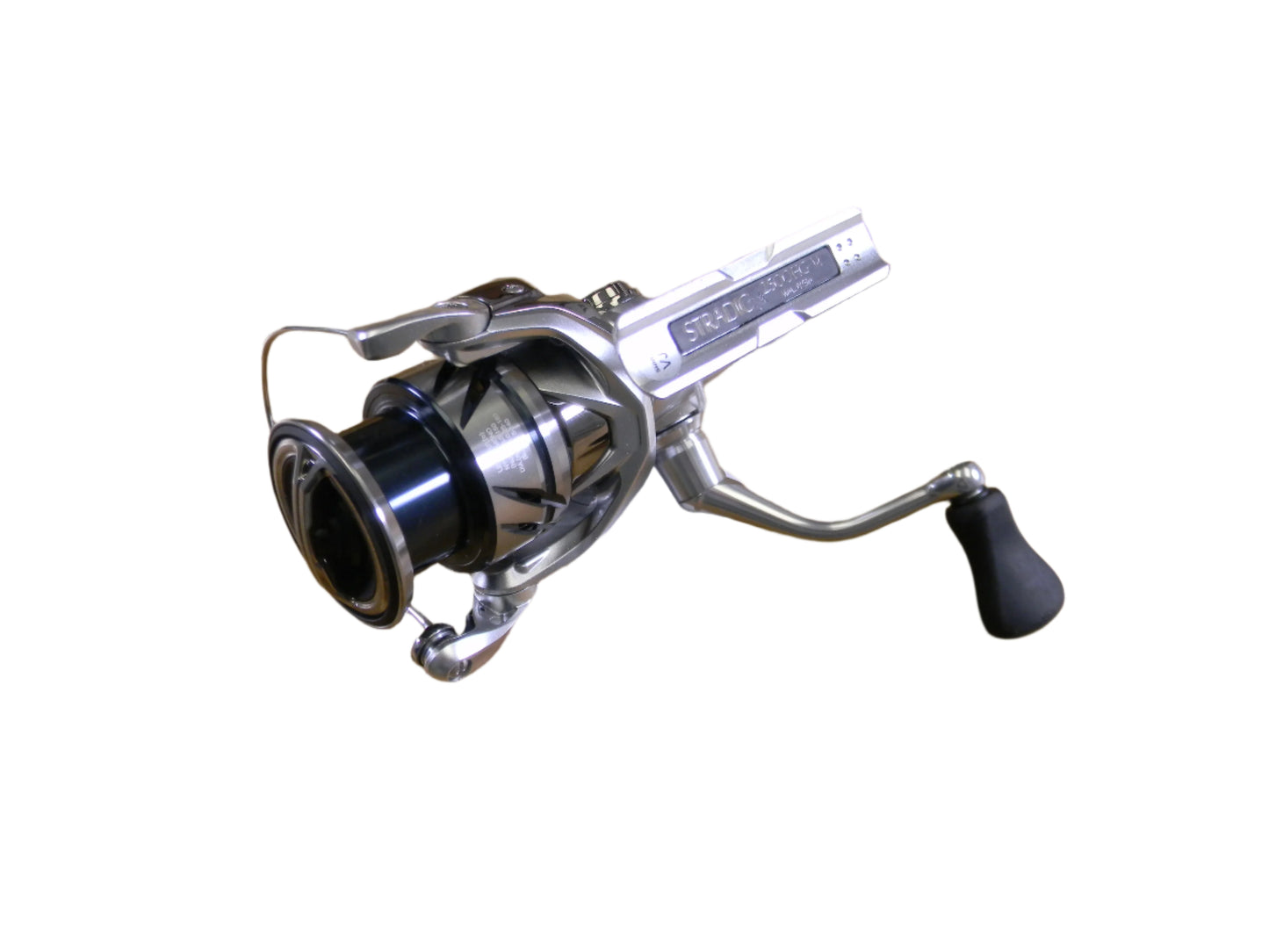 The Shimano Stradic ST2500HGFM is a used spinning reel featuring a silver finish with black spool and handle, perfect for attaching to a rod. Its sleek design makes it ideal for quality fishing enthusiasts participating in our Rod and Reel Trade-In program.