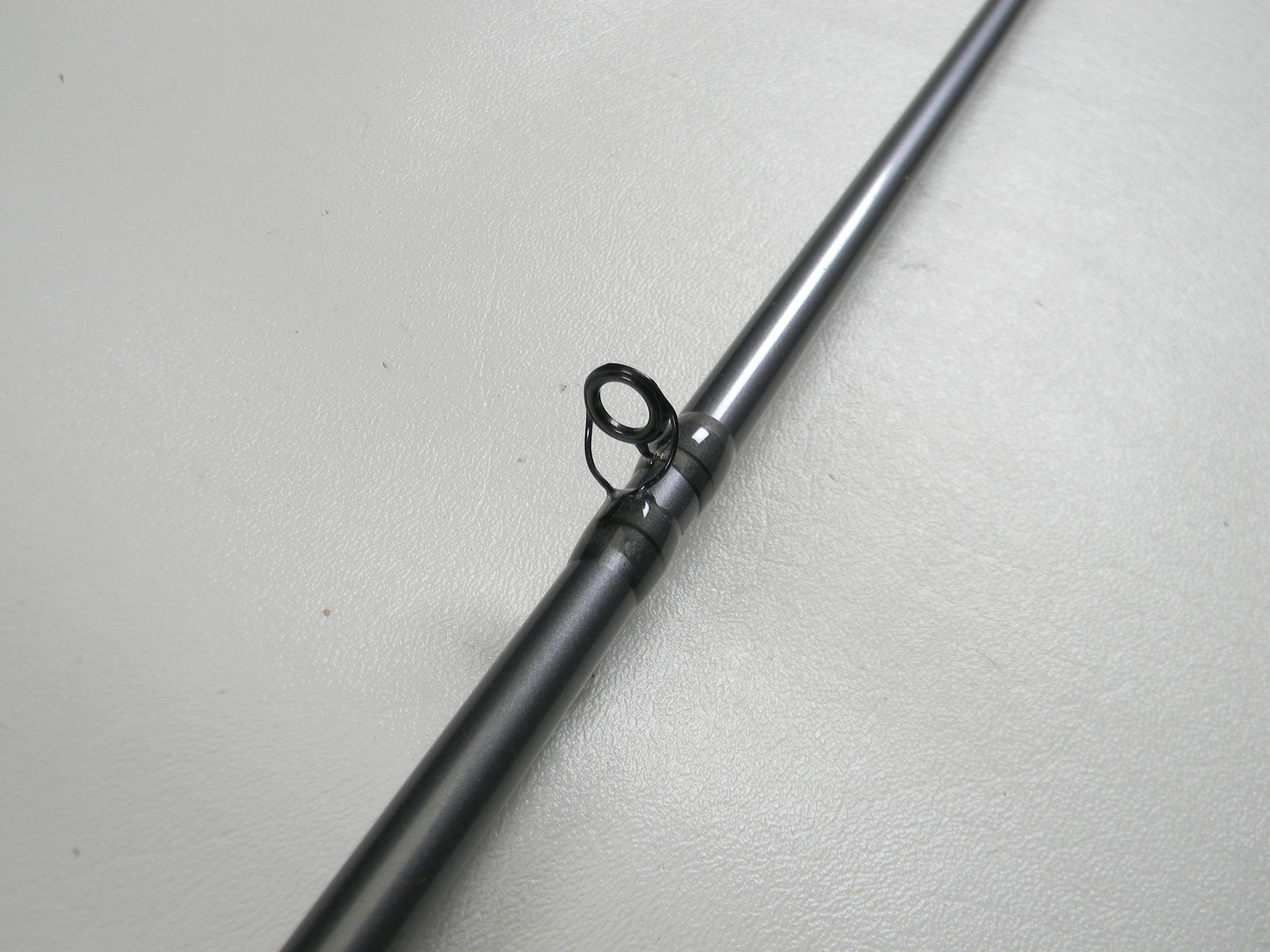 A close-up of the St. Croix Black Bass RIC73MHF 7'3" Medium Heavy Used Casting Rod in excellent condition, featuring a single line guide against a plain background, perfect for the Rod and Reel Trade-In Program and store credit offers.
