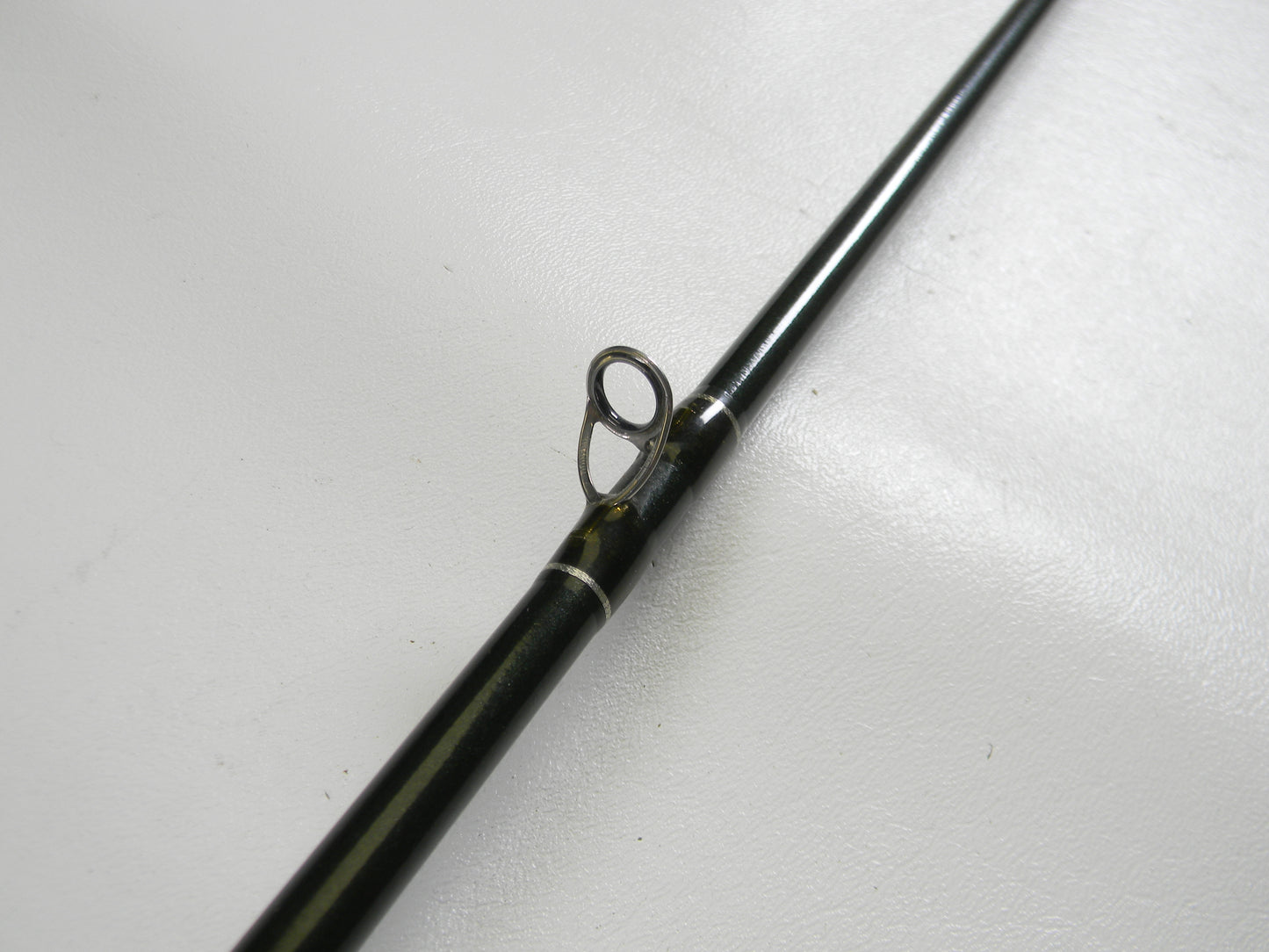 Close-up of a St. Croix Legend Elite EC68MHF 6'8" Medium Heavy used casting rod in very good condition, highlighting a metal line guide against a white background—ideal for those looking to upgrade with our Rod and Reel Trade-In Program.