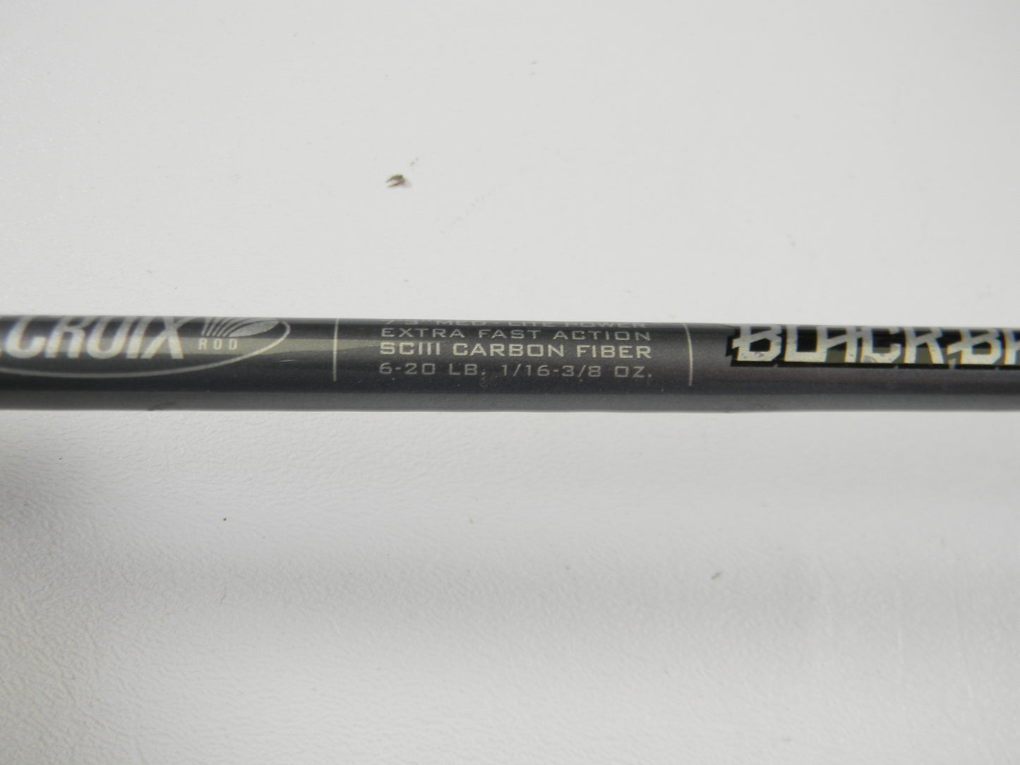 Close-up of the St. Croix Black Bass RIS73MLXF 7'3" Medium Light Used Spinning Rod in excellent condition, featuring "Extra Fast Action SCIII Carbon Fiber 6-20 lb, 1/16 - 3/8 oz." Eligible for our Rod and Reel Trade-In Program. Plain white background.