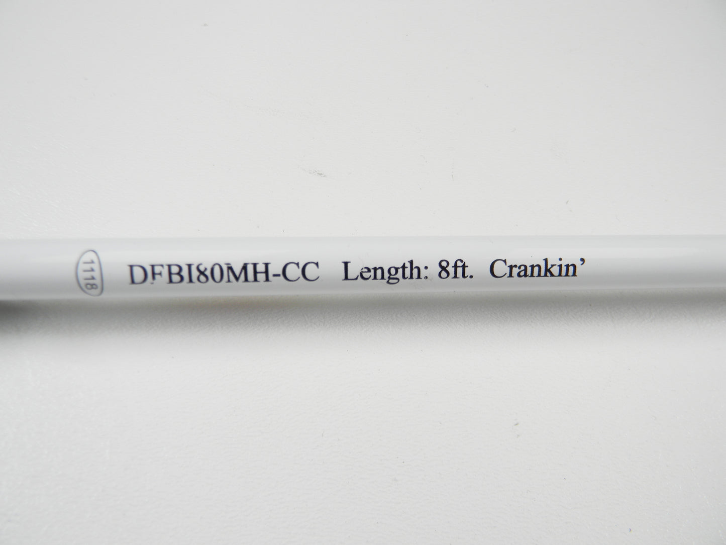 Close-up of a Duckett Black Ice DFBI80MH-CC 8'0" Medium Heavy Crankin' rod with black text, perfect for those upgrading through our Rod and Reel Trade-In Program. Set elegantly against a plain white background.