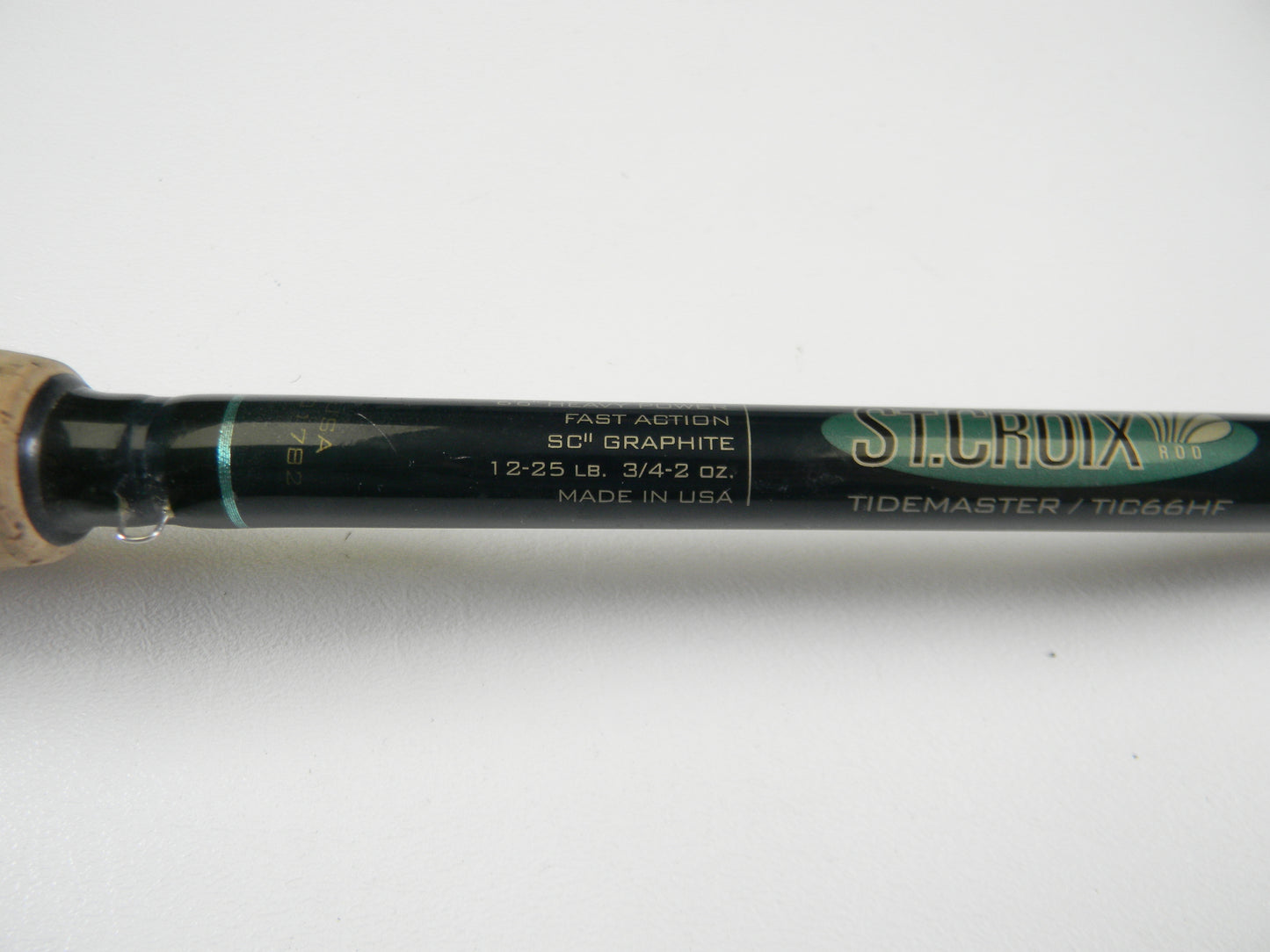 Close-up of a St. Croix Tidemaster TIC66HF, 6'6" heavy rod with fast action, SCII graphite, rated for 12-25 lb and 3/4-2 oz. Made in the USA. Upgrade through our Rod and Reel Trade-In Program to earn store credit by choosing this excellent condition used casting rod.