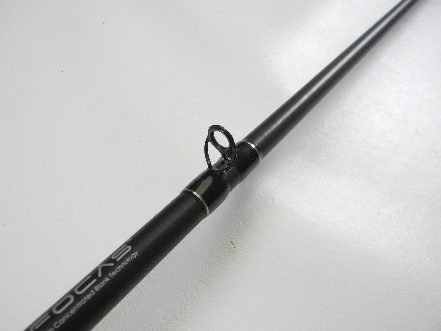Close-up of Lew's Signature Series TLS73H Frog 7'3" Heavy black casting rod, showcasing a guide ring against a white backdrop. Ideal for Rod and Reel Trade-In, this used gear is in excellent condition.