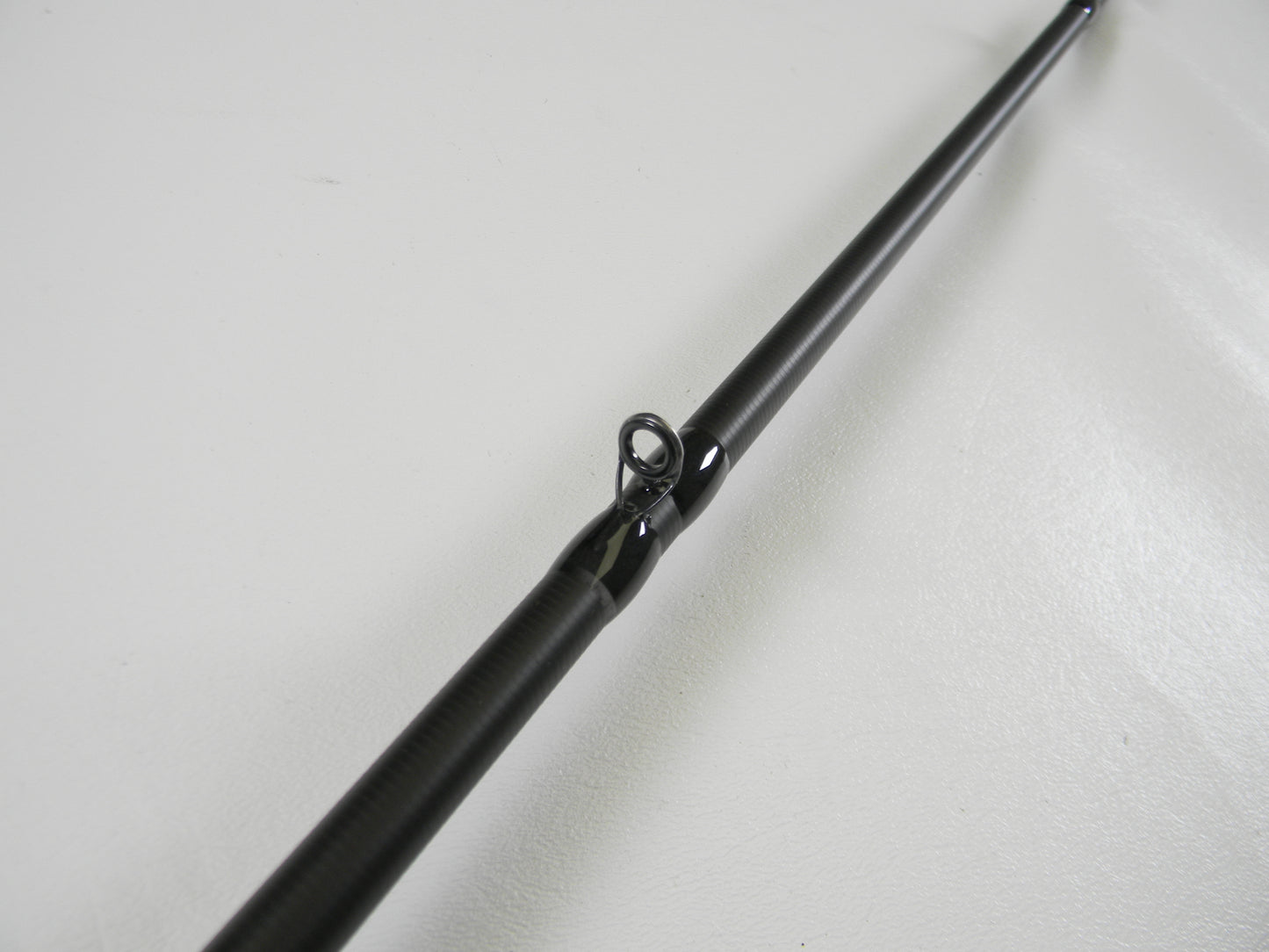 Close-up view of the Kistler KLX KLX-TCJ-70MH 7'0" Medium Heavy used casting rod guide against a white background, showcasing its sleek design. Ideal for our rod and reel trade-in program.