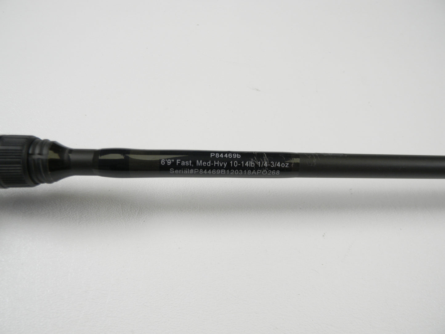 The Cashion P84469b 6'9" Medium Heavy used casting rod, in good condition, features details like "Fast, 10-14lb, 1/2-3/4oz" and the serial number "P84469B120318APO268." It's ideal for a rod and reel trade-in to earn store credit. The sleek black shaft is displayed on a white surface.