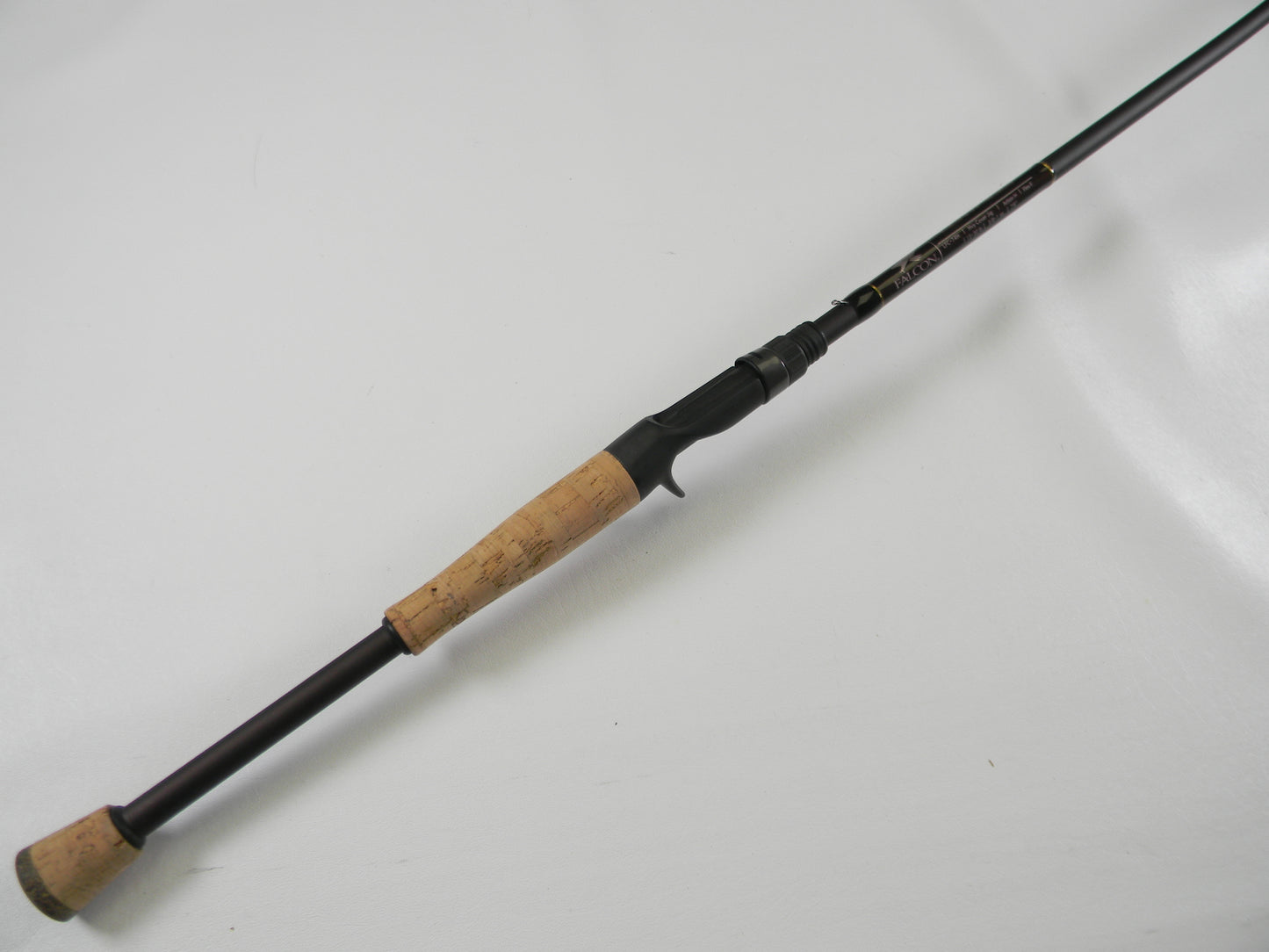The Falcon Lowrider LFC74H, a 7'4" used casting rod with a cork handle and black body, features a sturdy metal reel seat. It's an excellent choice for our Rod and Reel Trade-In Program, offering unbeatable value for those seeking quality gear.