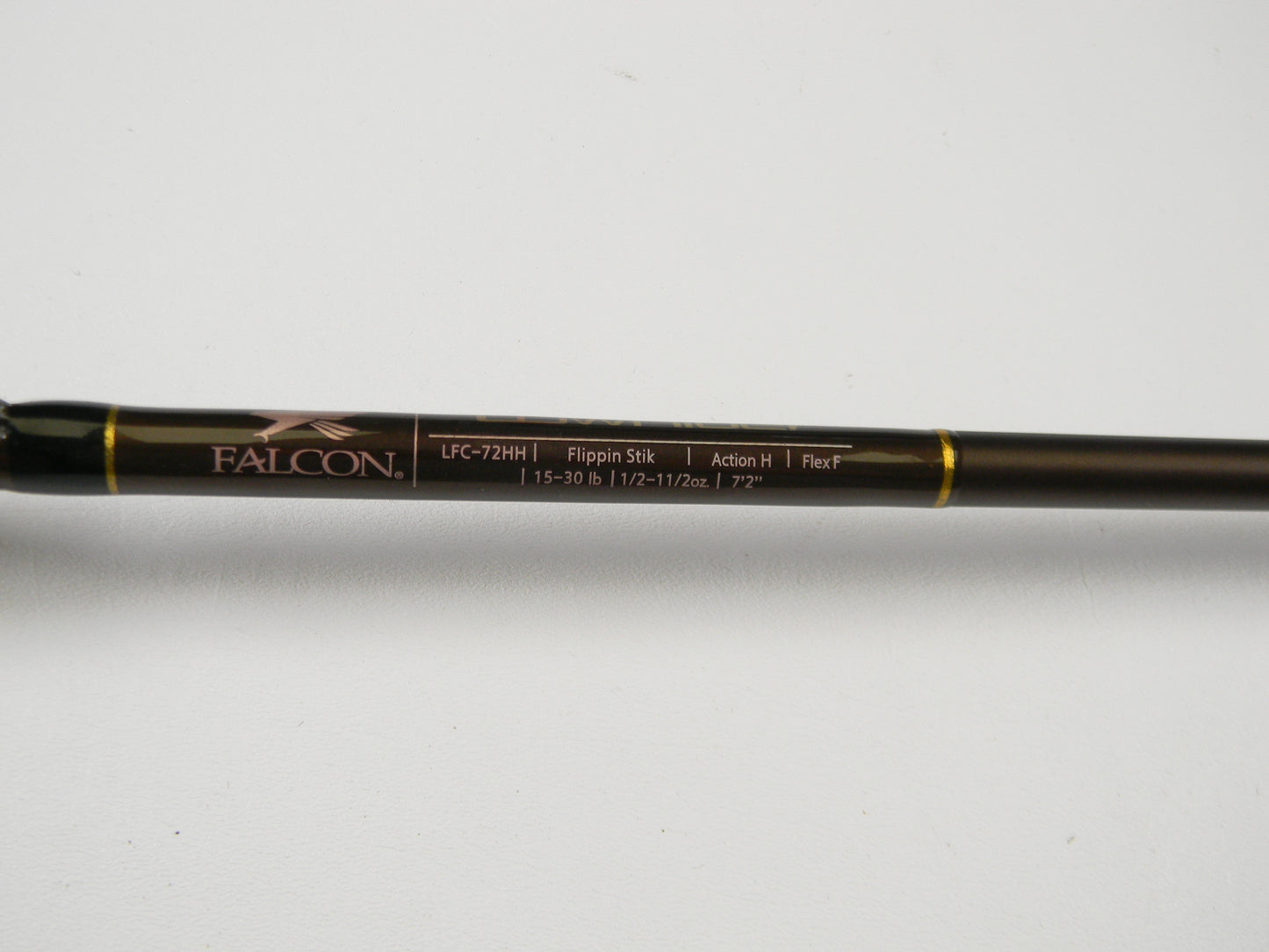 Close-up of a Falcon Lowrider LFC-72HH Flippin Stik 7'2" Heavy casting rod in excellent condition, featuring "15-30 lb 1/2-1 1/2 oz," "Action H," and "Flex F." Add this to your tackle collection and use the Rod and Reel Trade-In Program for valuable store credit.