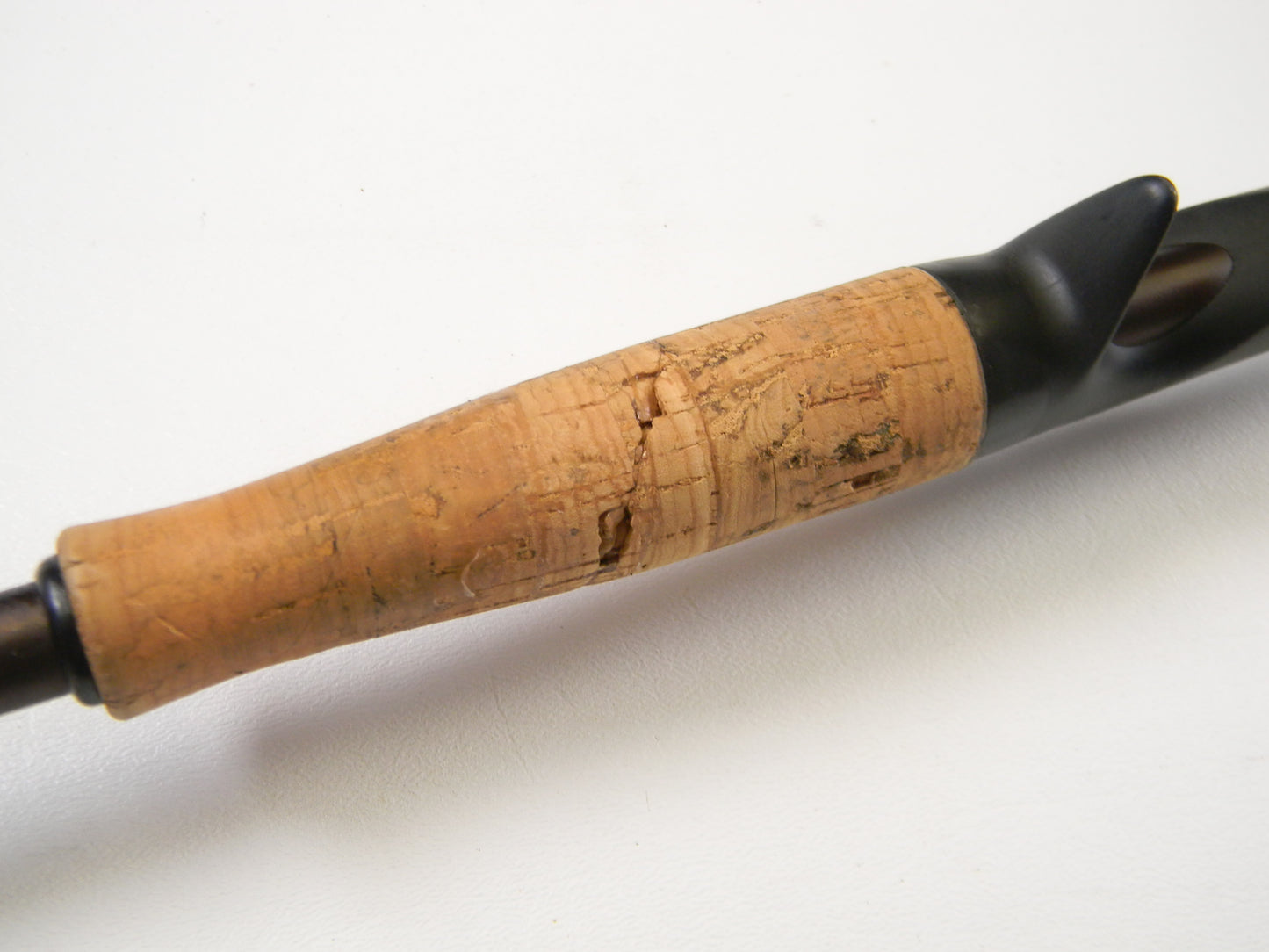 Close-up of Falcon Lowrider LFC-72HH Flippin Stik 7'2" Heavy casting rod handle with a cork grip and black accents against a white background. Perfect for our Rod and Reel Trade-In Program, this used Falcon gear can earn you valuable store credit for your next adventure.
