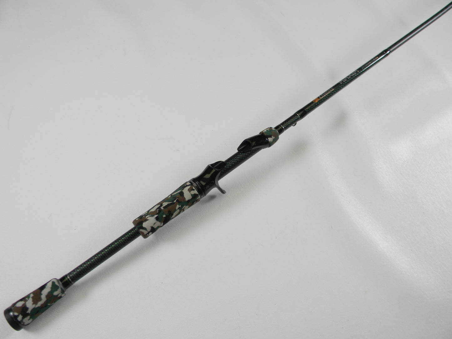 The Phenix Maxim PHX-MAX-C610MH 6'10" Medium Heavy casting rod, featuring a camouflage-patterned handle and reel seat with a textured grip for enhanced handling, is perfect for our Rod and Reel Trade-In Program—trade your used gear and earn store credit!.