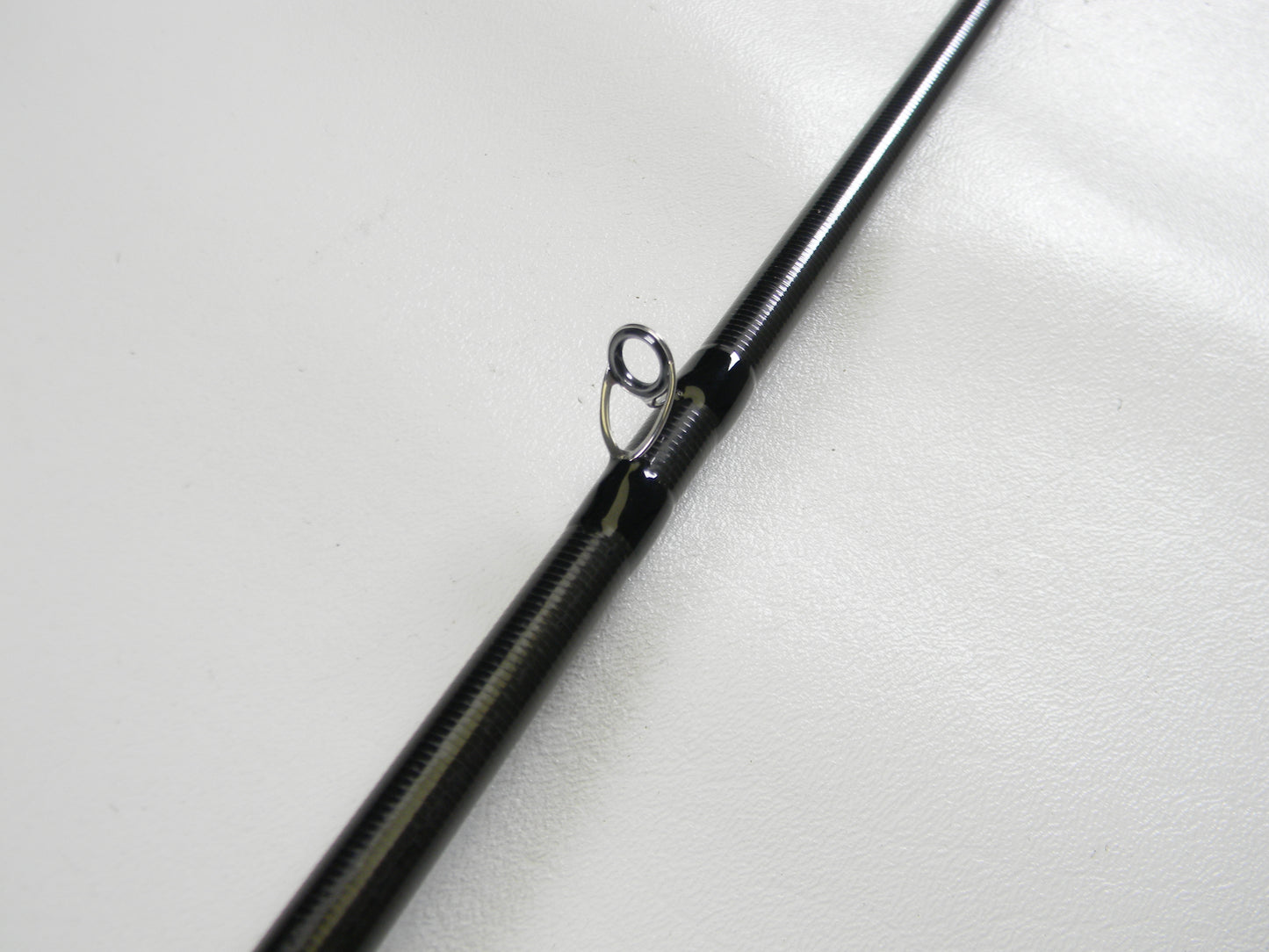 Close-up of a 13 Fishing Envy Black 3 EB3C68M 6'8" Medium used casting rod guide in excellent condition, ideal for anglers interested in quality pre-owned gear from 13 Fishing.