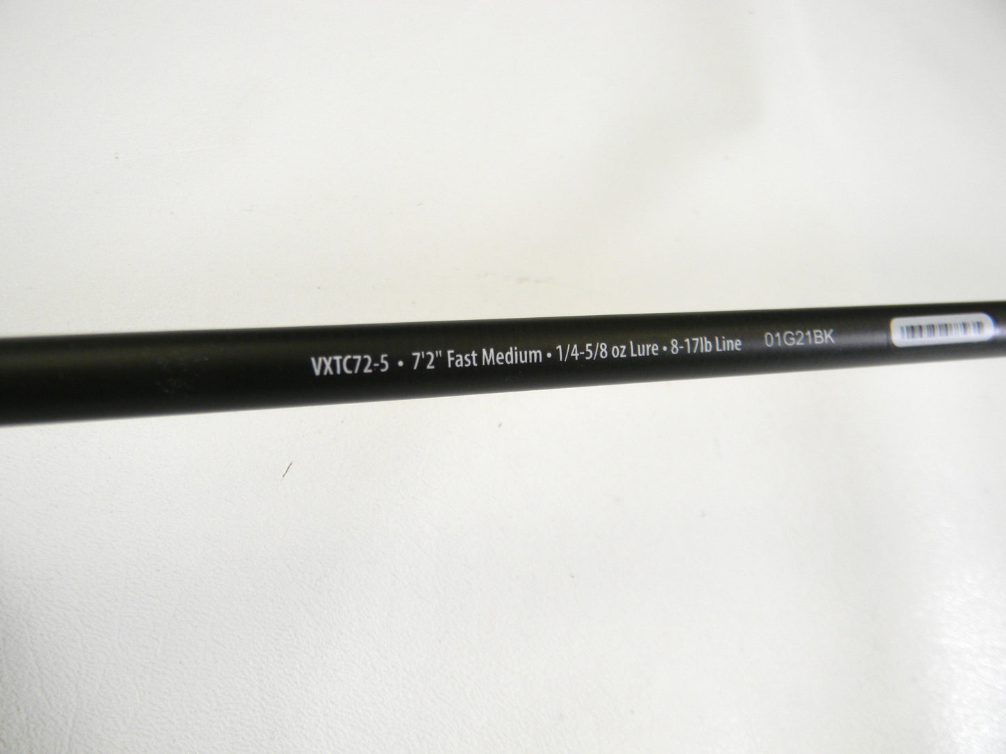 Close-up of the Abu Garcia Veritas Tournament VXTC72-5 7'2" Medium casting rod against a white background. This black rod, with white text showing specs like measurements and line weight capacity, is perfect for upgrading used gear through our Rod and Reel Trade-In program. Mint condition!.