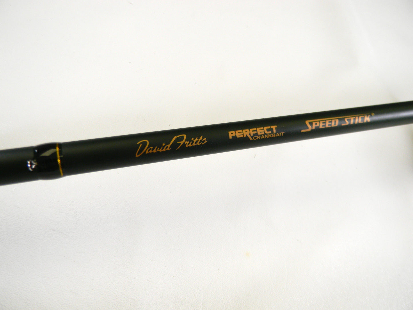 A close-up of the Lew's David Fitts Perfect Crankbait LDFP76MH 7'6" Medium Heavy casting rod in mint condition, featuring a black design with subtle orange accents and "David Fritts PERFECT CRANKBAIT SPEED STICK" text. Ideal for Rod and Reel Trade-Ins to upgrade gear with store credit.