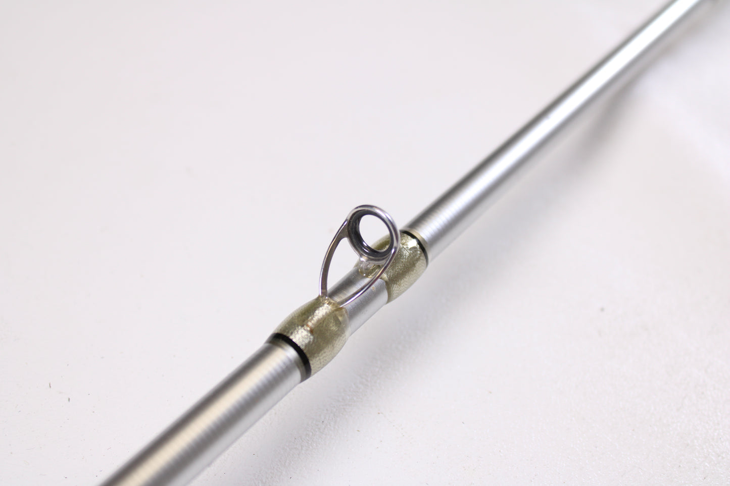 Close-up of a Denali Android ADC704WJ 7'0" Heavy - Used Casting Rod in good condition, highlighting a silver guide with wrapped thread—ideal for those considering our Rod and Reel Trade-In Program or quality used gear.