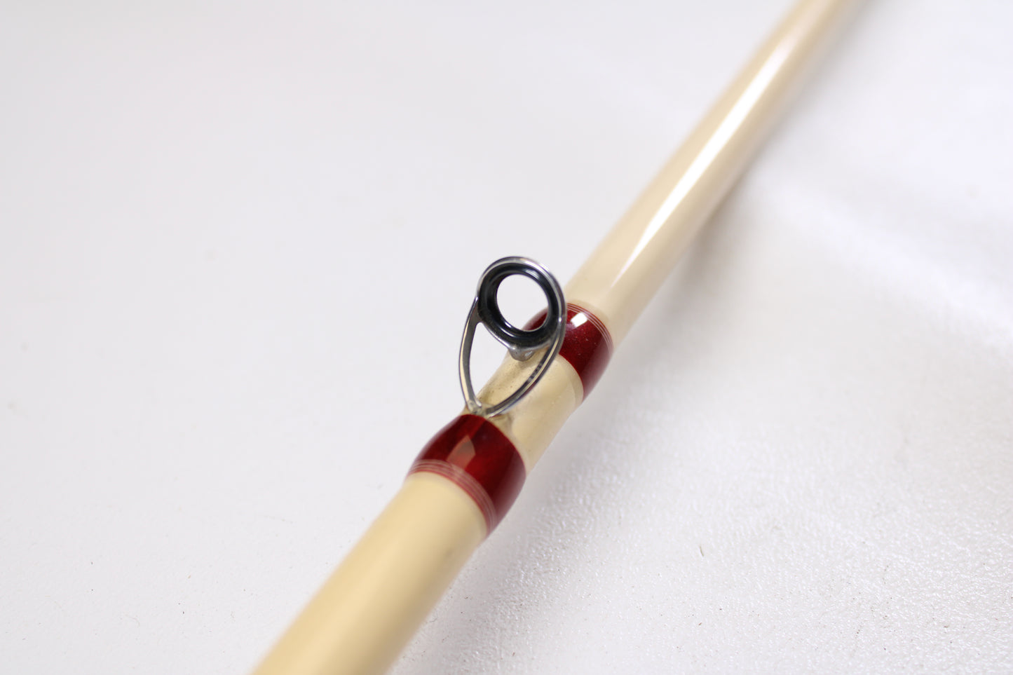 Close-up of a Doomsday Tackle Co. The 47 T47C-673F 7'3" Heavy used casting rod in very good condition, featuring a beige finish and metal guide ring—ideal for value-seekers using our rod and reel trade-in program.