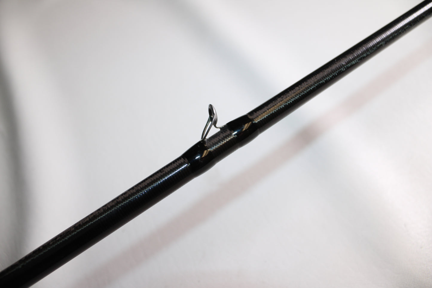 A close-up of the 13 Fishing Envy Black EB3C79C Crank casting rod, in good used condition, shows a single metal guide eyelet against a plain white background.