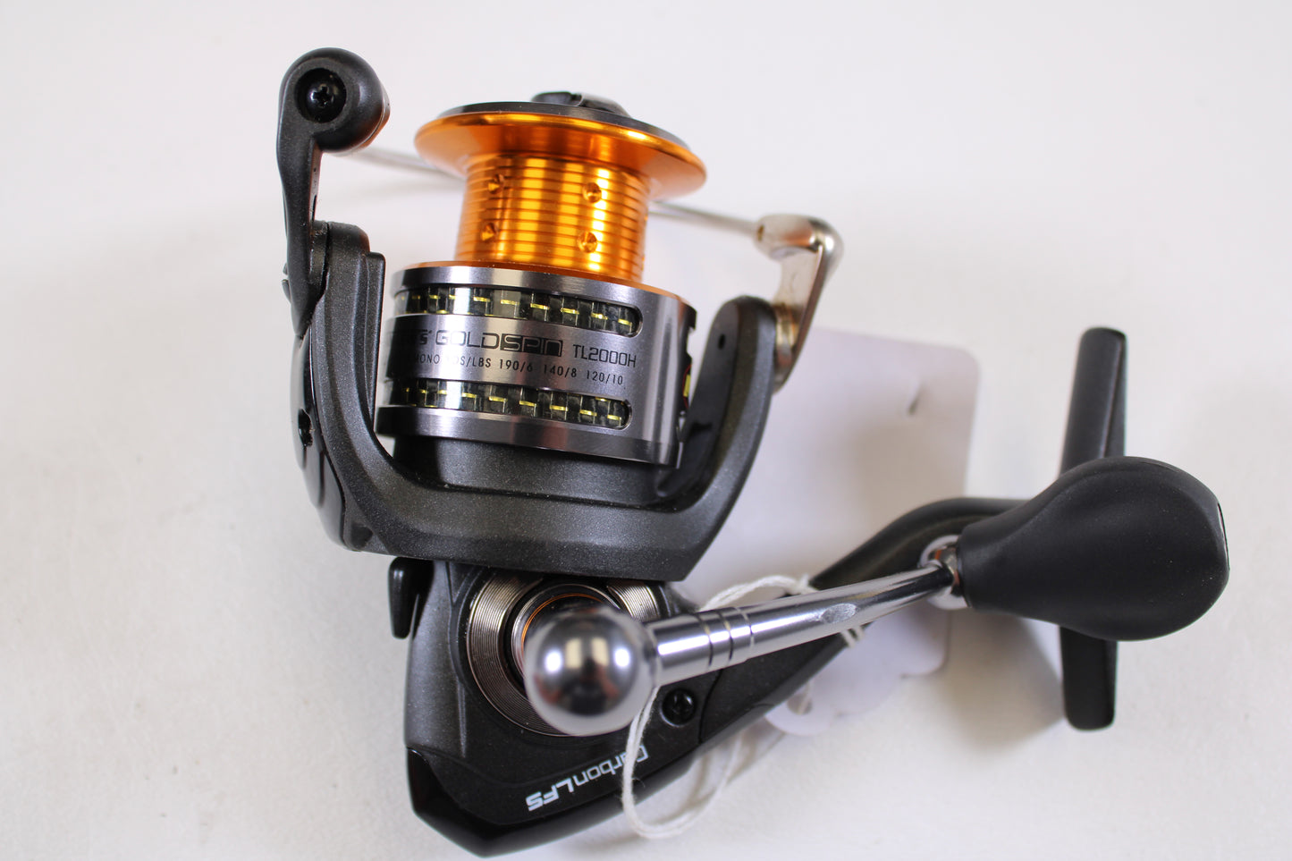 A close-up of the Lew's Gold Spin Carbon LFS TL2000H 6:1:1 used spinning reel in excellent condition, featuring an orange spool, black handle, and silver accents—great for upgrading your tackle with Lew’s quality gear.