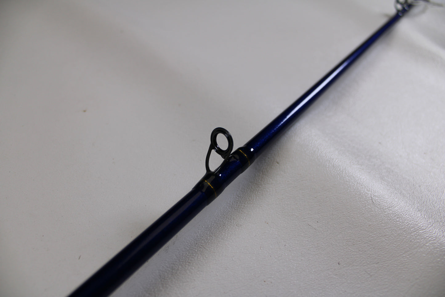 A close-up of the St. Croix Legend Tournament Bass LBTC72MHMF Finesse Carbon Cranker 7'2" Medium Heavy casting rod in excellent used condition, highlighting a line guide—ideal for anglers seeking top-quality pre-owned gear.