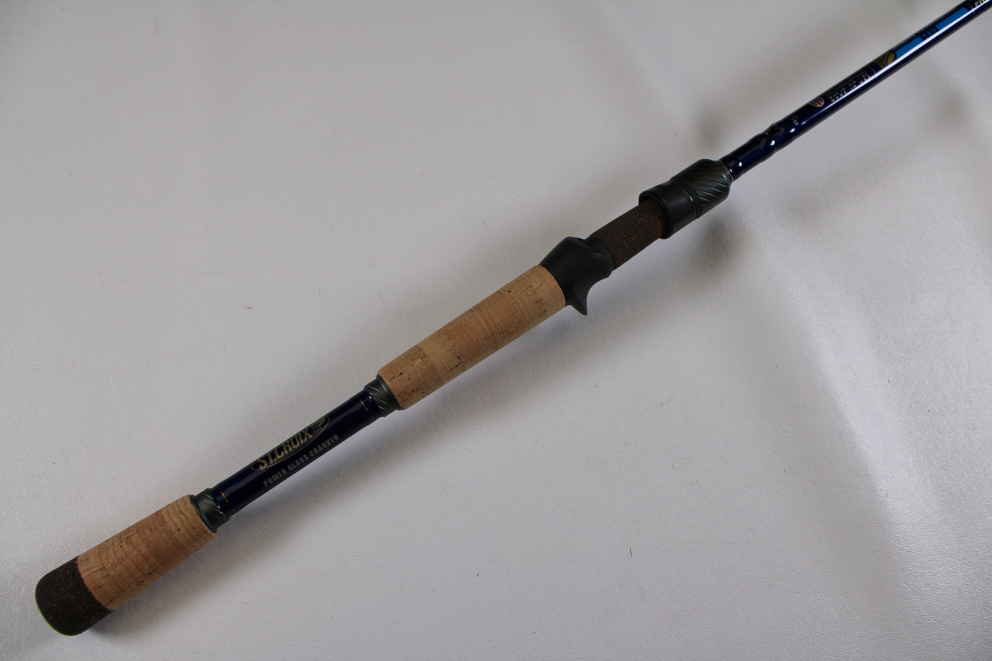 The St. Croix Legend Tournament Bass LBTC74MHM Power Glass Cranker 7'4" Medium Heavy Used Casting Rod, shown with a cork handle and dark blue body—ideal for the Rod and Reel Trade-In Program or seeking Used Gear Condition.