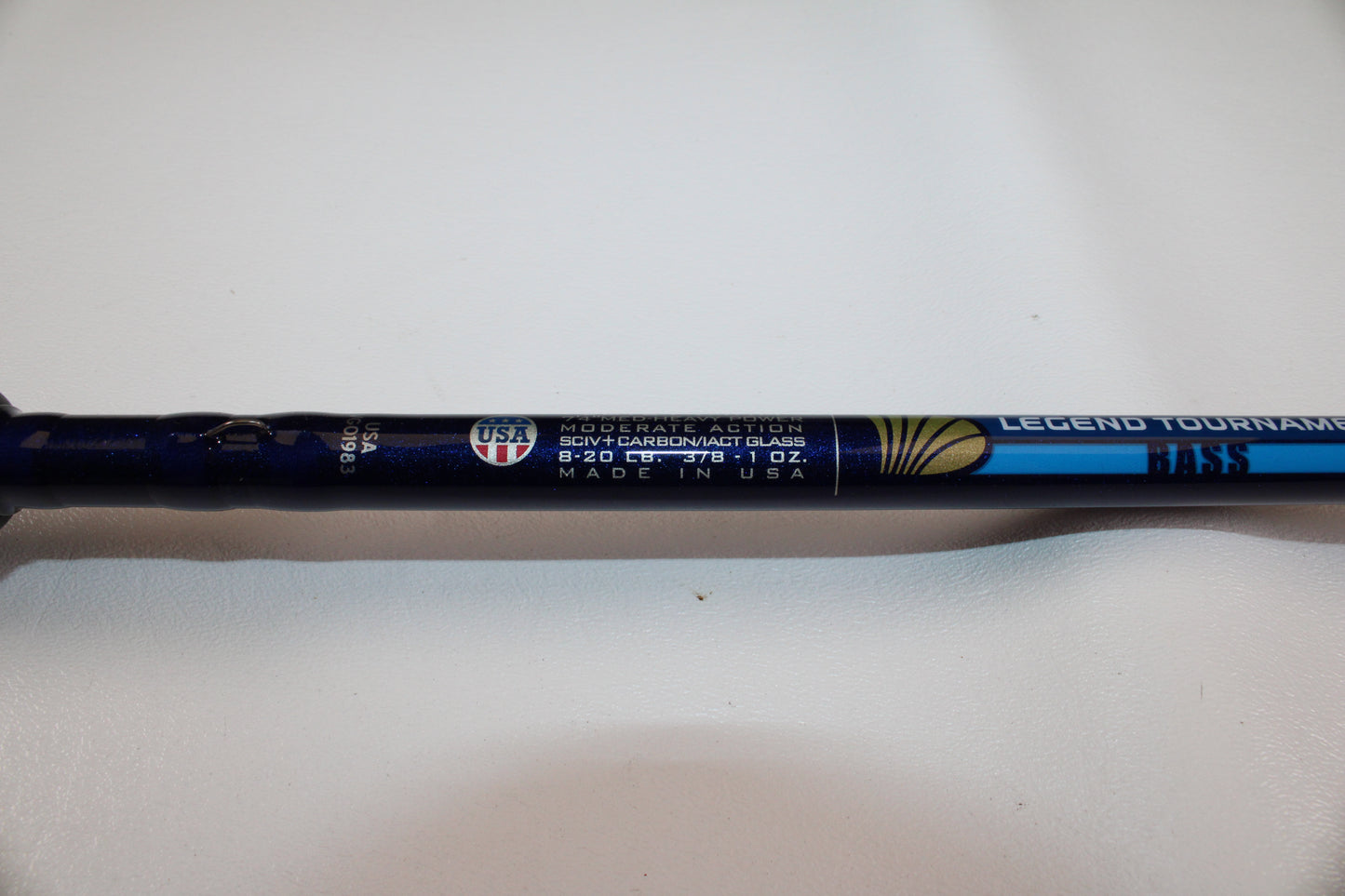 A close-up of a St. Croix Legend Tournament Bass LBTC74MHM Power Glass Cranker 7'4" Medium Heavy Used Casting Rod in excellent condition, featuring moderate action, SCLV carbon/glass, 8–20 lb line, and 3/8–1 oz. lure specs.