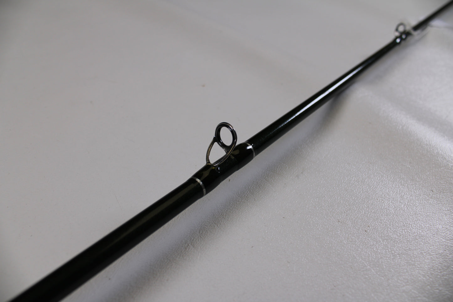 A close-up of a St. Croix Legend Elite EC70MF 7'0" Medium used casting rod in excellent condition, highlighting a line guide—ideal for those interested in quality used gear or our Rod and Reel Trade-In Program.