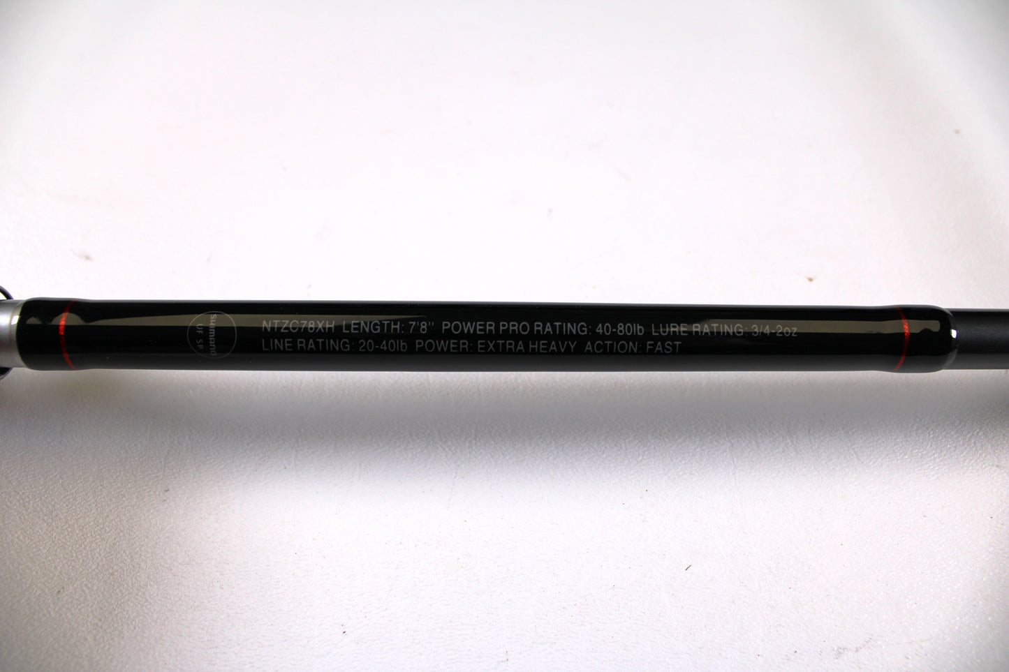 Close-up of a Shimano Intenza NTZC78XH 7'8" XH Used Casting Rod in excellent condition, showing specs in white: 7’8” length, 40-80lb Power Pro rating, and extra heavy power—ideal for Rod and Reel Trade-In or gear assessment.