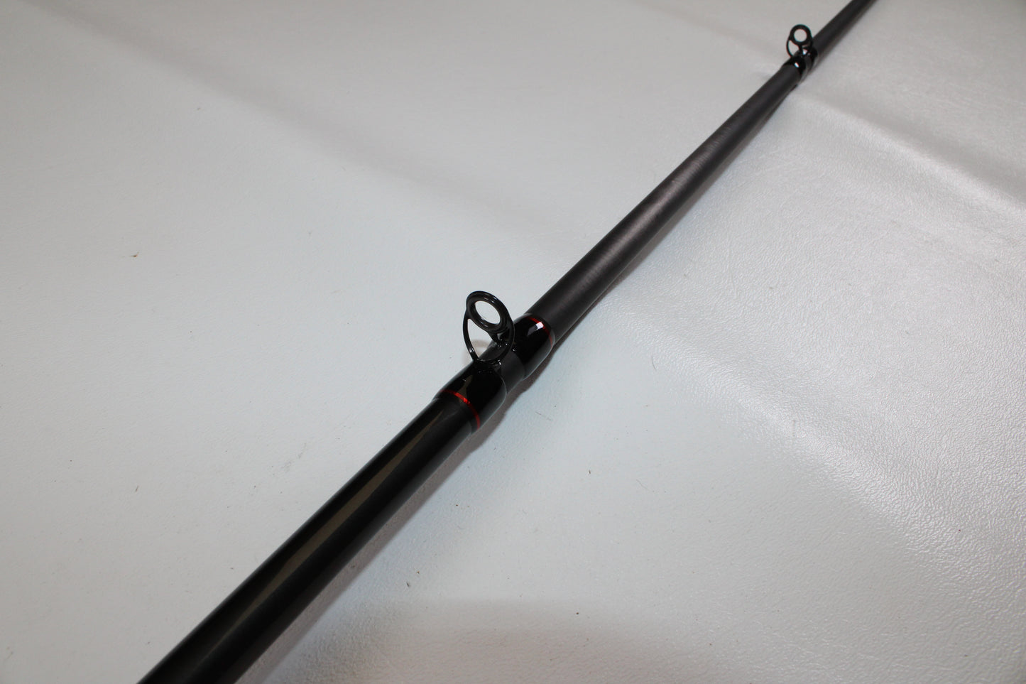 Close-up of a Shimano Intenza NTZC78XH 7'8" XH Used Casting Rod in excellent condition, showing two line guides—ideal for evaluating gear or considering a Rod and Reel Trade-In.