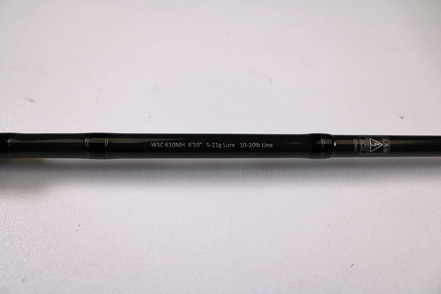 A close-up of a Legit Design Wild Side WSC 610MH 6'10" Medium Heavy Used Casting Rod in excellent condition, with specs "5-21g Lure, 10-20lb Line" shown, ideal for trade-in program fans, set against a plain white background.