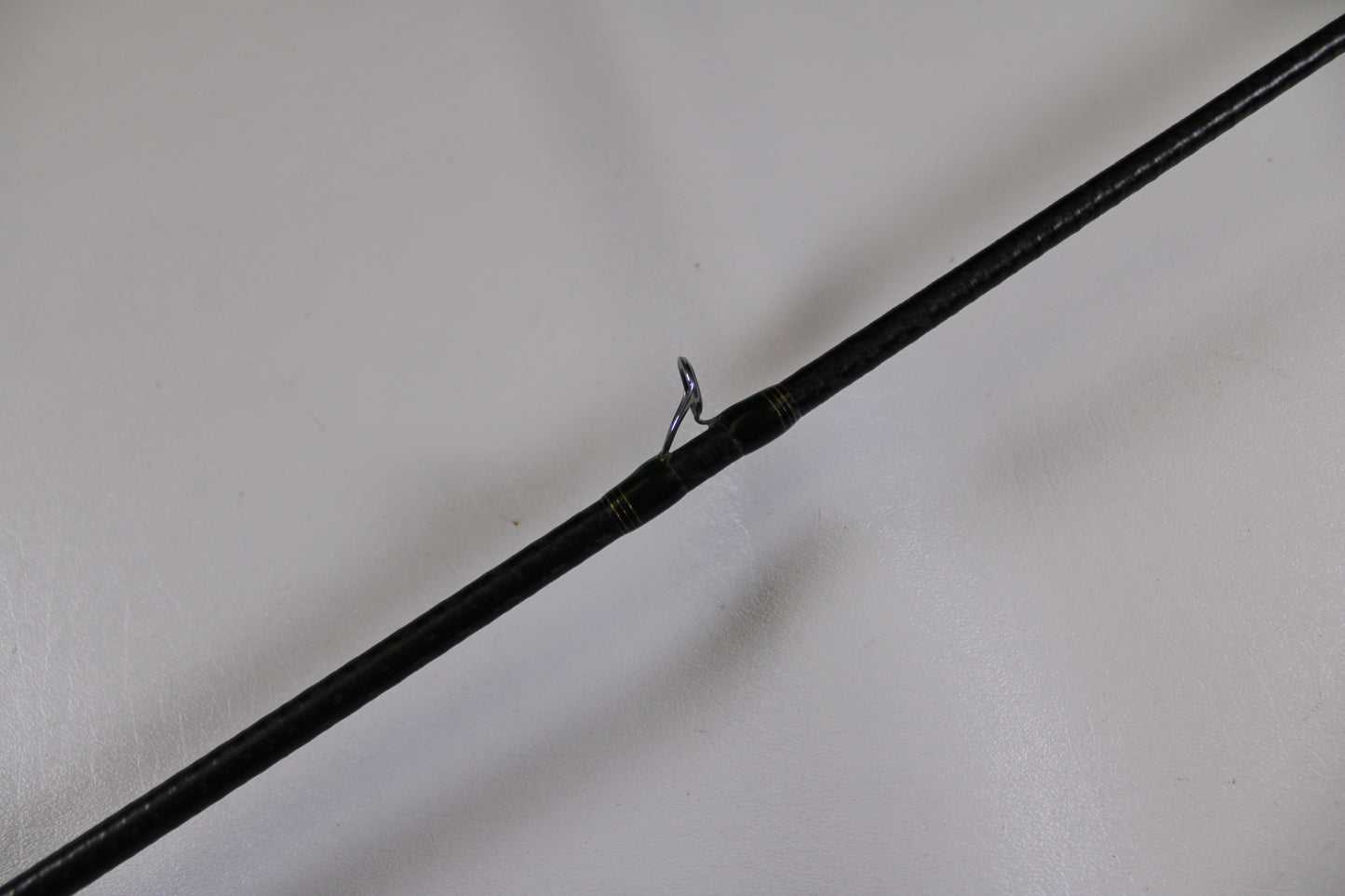 A close-up of a Megabass Orochi XX Aaron Martens F4.1/2-68XX Jerkbait Special used casting rod in fair condition highlights a single metal guide ring—ideal for those interested in used gear or our Rod and Reel Trade-In program.