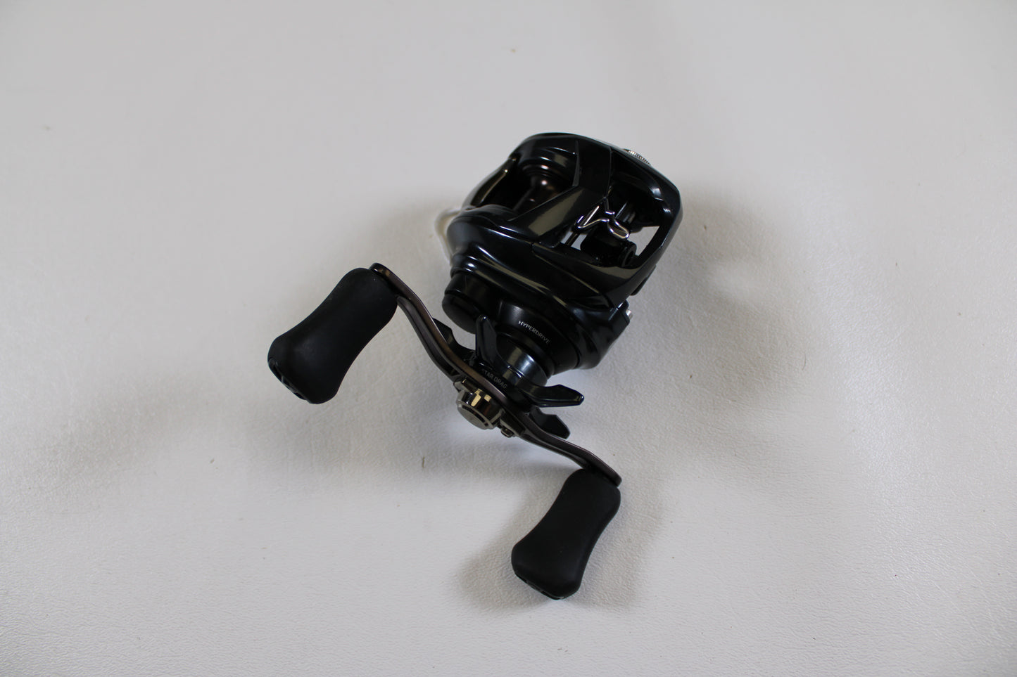 A Daiwa Tatula SV 70 TTUSV70XH Used Casting Reel in excellent condition is displayed on a white surface—ideal for our Rod and Reel Trade-In Program if you want to upgrade your gear and earn store credit.