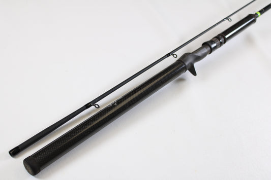 The G. Loomis E6X Hot Shot 1021-2C HSR GH 8'6" Mag Medium 2pc Casting Rod (Used, Good Condition) features a black finish with a textured handle and two visible line guides—ideal for our rod and reel trade-in program.