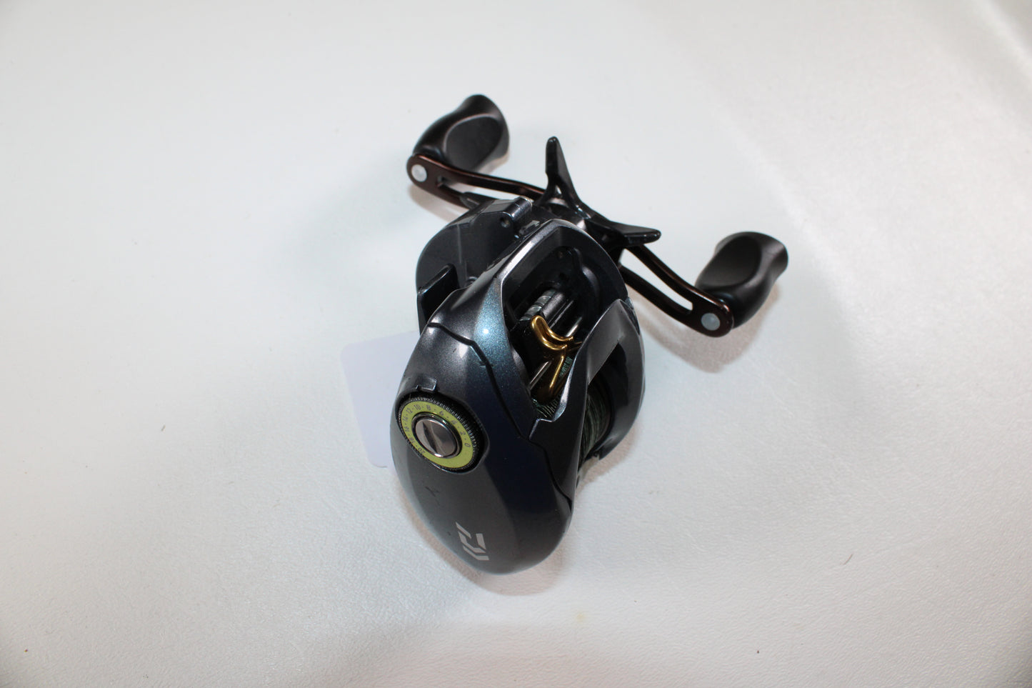The Daiwa Zillion SV TW JDM 9.1:1 casting reel in good used condition features dual handles, metallic accents, and a visible spool—ideal for anglers to upgrade through our Rod and Reel Trade-In Program.
