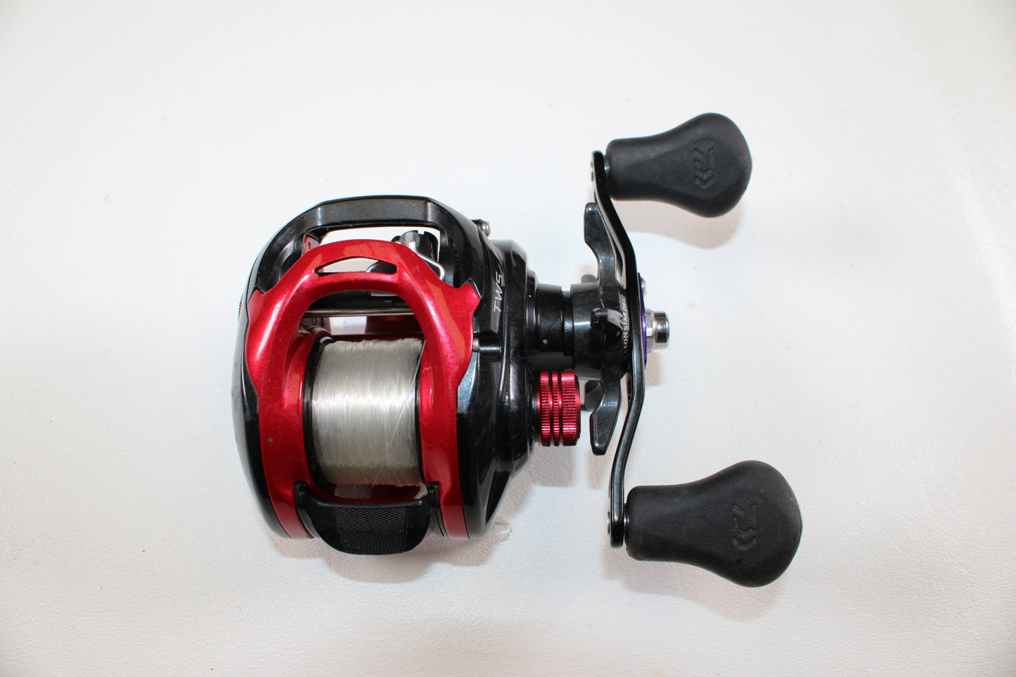 A close-up of a Daiwa Tatula CT Type-R CT100XS 8.1:1 gear ratio casting reel in very good used condition, shown with line on the spool against a white background—ideal for upgrading or shopping quality used Daiwa gear.