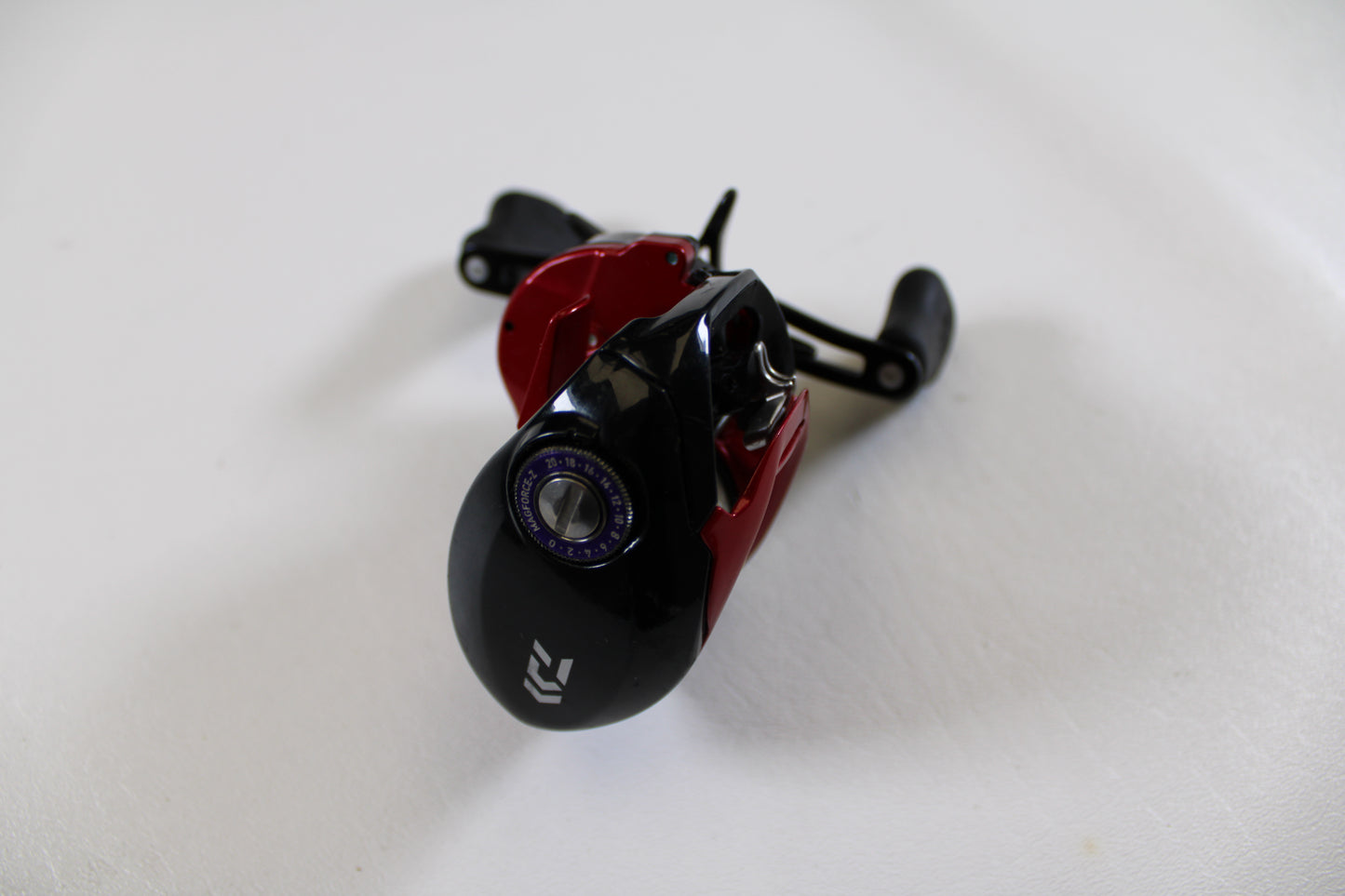 A close-up of a Daiwa Tatula CT Type-R CT100XS 8.1:1 casting reel in black and red, shown in very good used condition—ideal for upgrading through our Rod and Reel Trade-In Program for store credit.