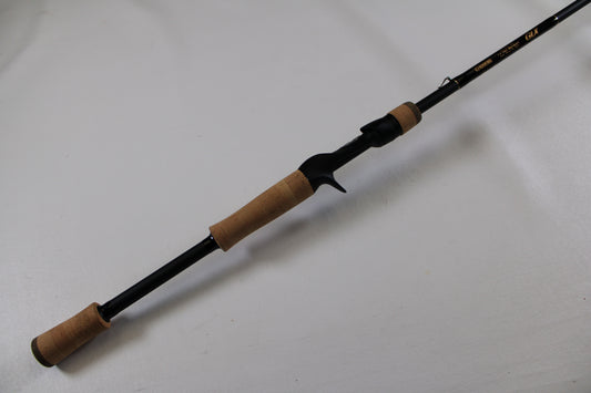 The G. Loomis GLX 873c BJR 7'3" Medium Heavy Used Casting Rod is shown—an excellent-condition black rod with cork grips, ideal for anglers seeking quality pre-owned gear or joining our rod/reel trade-in program.