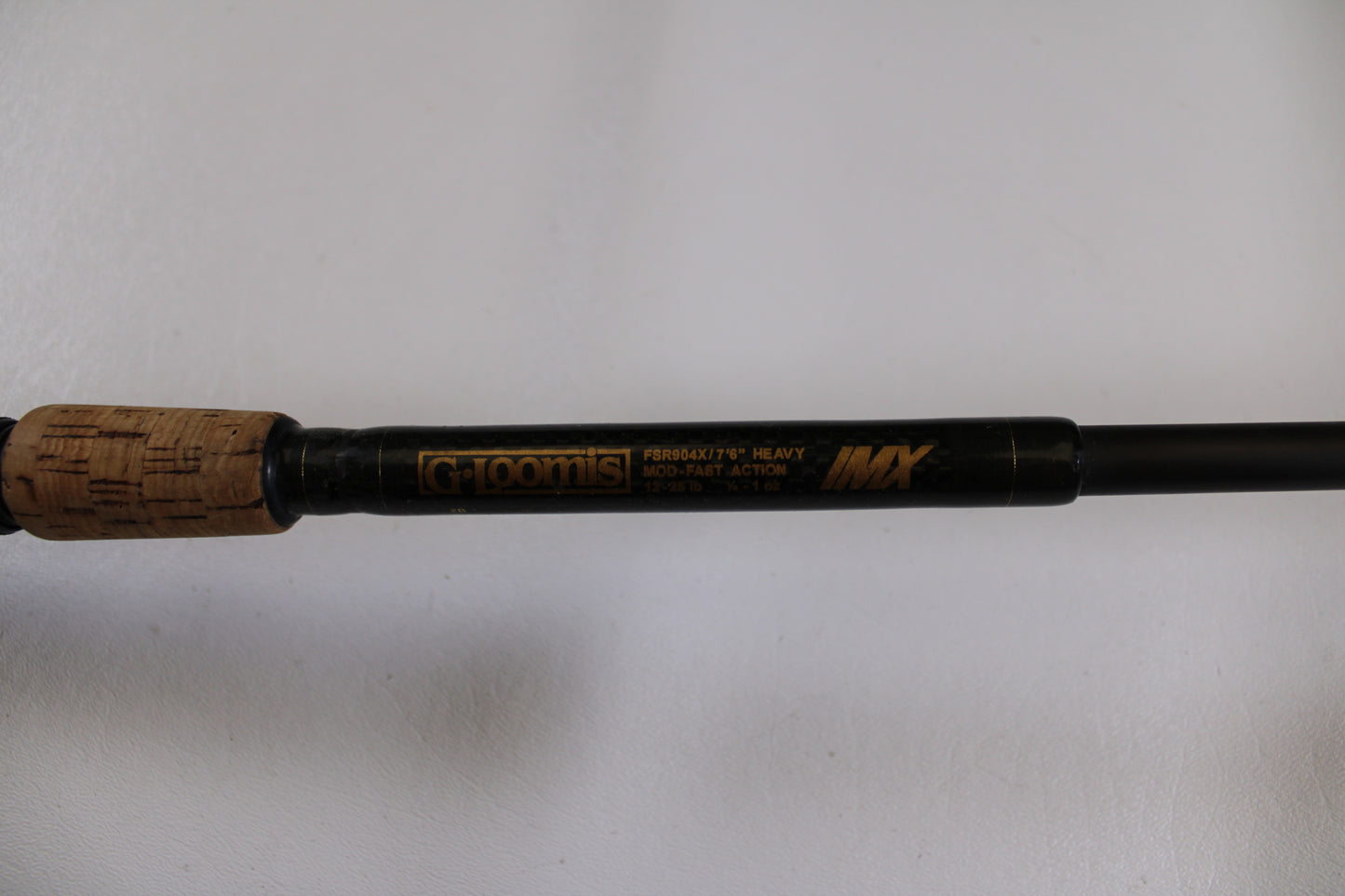 Close-up of the G. Loomis FSR904X IMX 7'6" Heavy Used Casting Rod with cork handle, in good condition. Eligible for our Rod & Reel Trade-In—exchange your used gear for store credit today!.