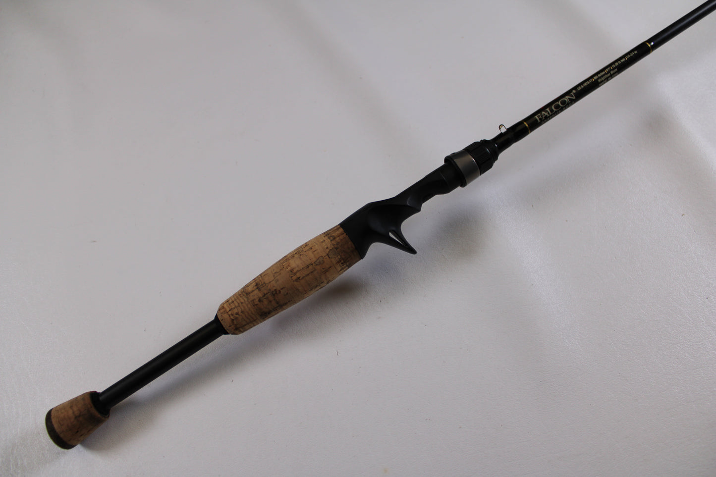 The Falcon Cara T7 CC-5-167S Weightless Worm Used Casting Rod, in good condition, features a cork handle and black reel seat, making it a lightweight choice for freshwater anglers and ideal for our Rod and Reel Trade-In Program.
