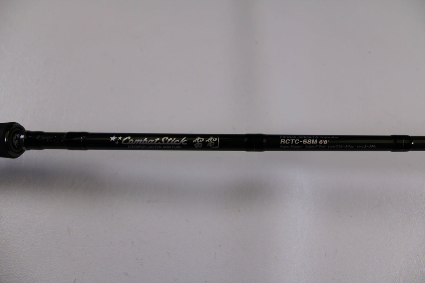 A close-up of the Evergreen Combat Stick RCTC-68M, a used casting rod in excellent condition, shows its model details and "Combat Stick" text on the shaft against a white background—ideal for our Rod and Reel Trade-In Program.