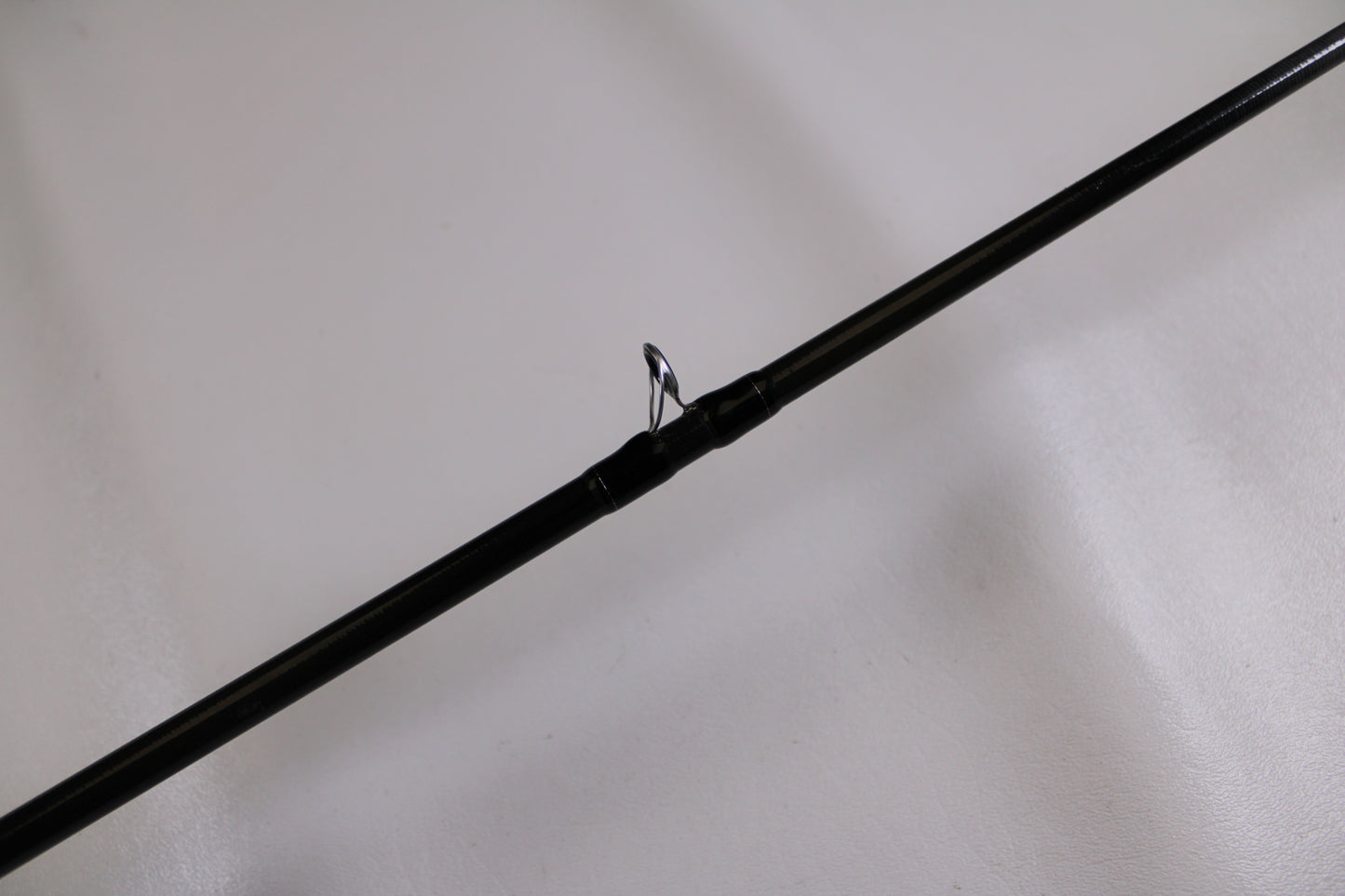 A close-up of the Evergreen Combat Stick RCTC-68M, a used casting rod in excellent condition, highlights its line guide—ideal for anyone seeking quality pre-owned gear or considering our Rod and Reel Trade-In Program.