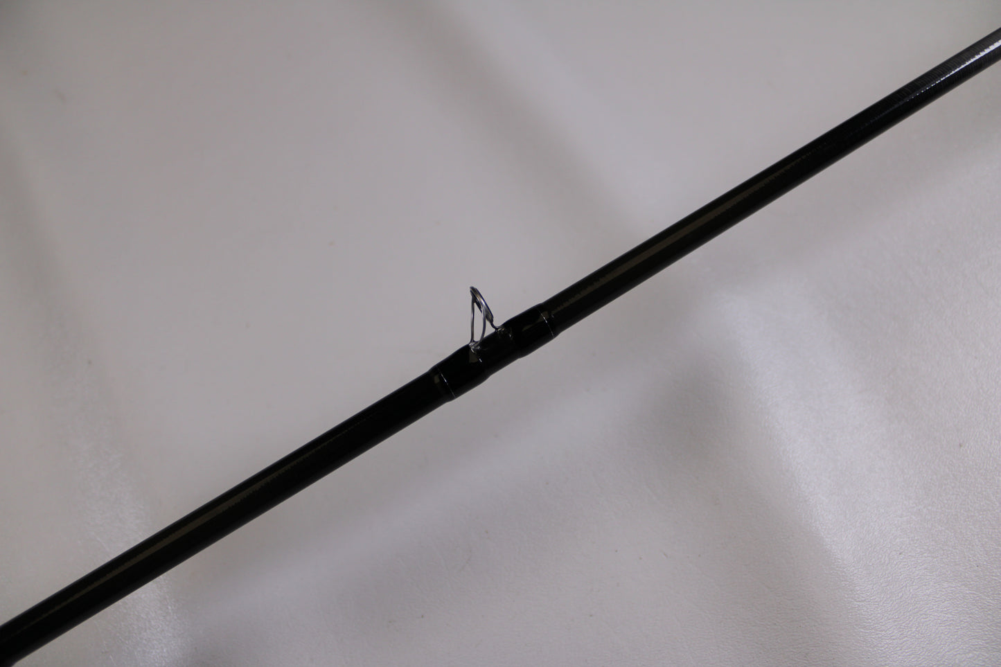 A close-up of the Evergreen Combat Stick RCTC-73MH Used Casting Rod in excellent condition, highlighting a rod guide—ideal for those looking to upgrade with our Rod and Reel Trade-In Program.
