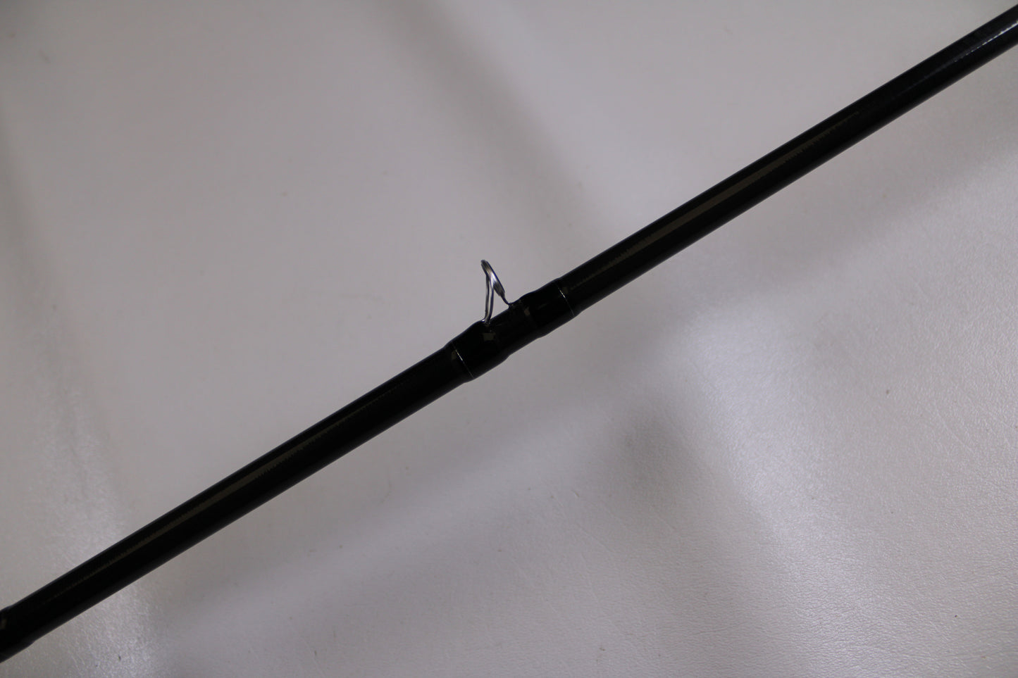 A close-up of the Evergreen Combat Stick RCTC-78XH—Used Casting Rod in excellent condition, featuring a metal guide ring against a plain white background—ideal for those trading in used gear for store credit or the Rod and Reel Trade-In Program.