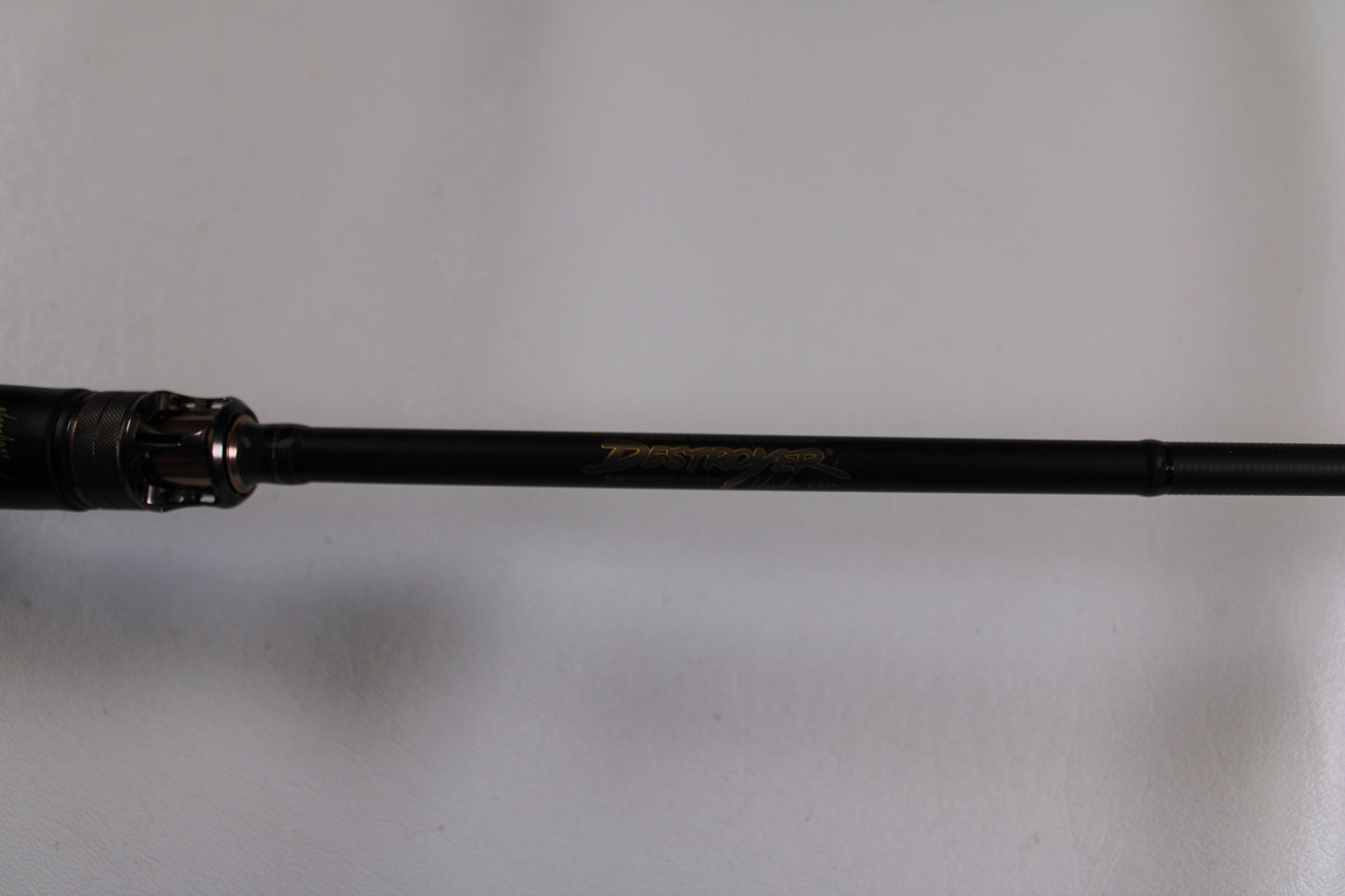A close-up of the Megabass Destroyer P5 F4-66X Used Casting Rod in excellent condition, featuring gold “Destroyer” lettering on a black shaft—perfect for those exploring our Rod and Reel Trade-In Program or quality used gear.