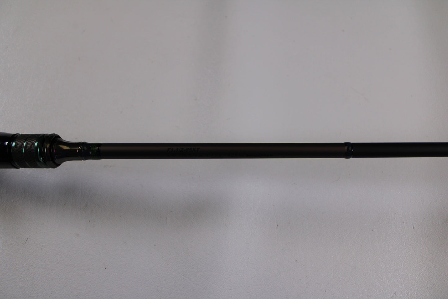 A close-up of the Megabass Orochi X10 F1.1/2-65XT Cliffhanger used casting rod in excellent condition—ideal for highlighting quality gear in our Rod and Reel Trade-In program.