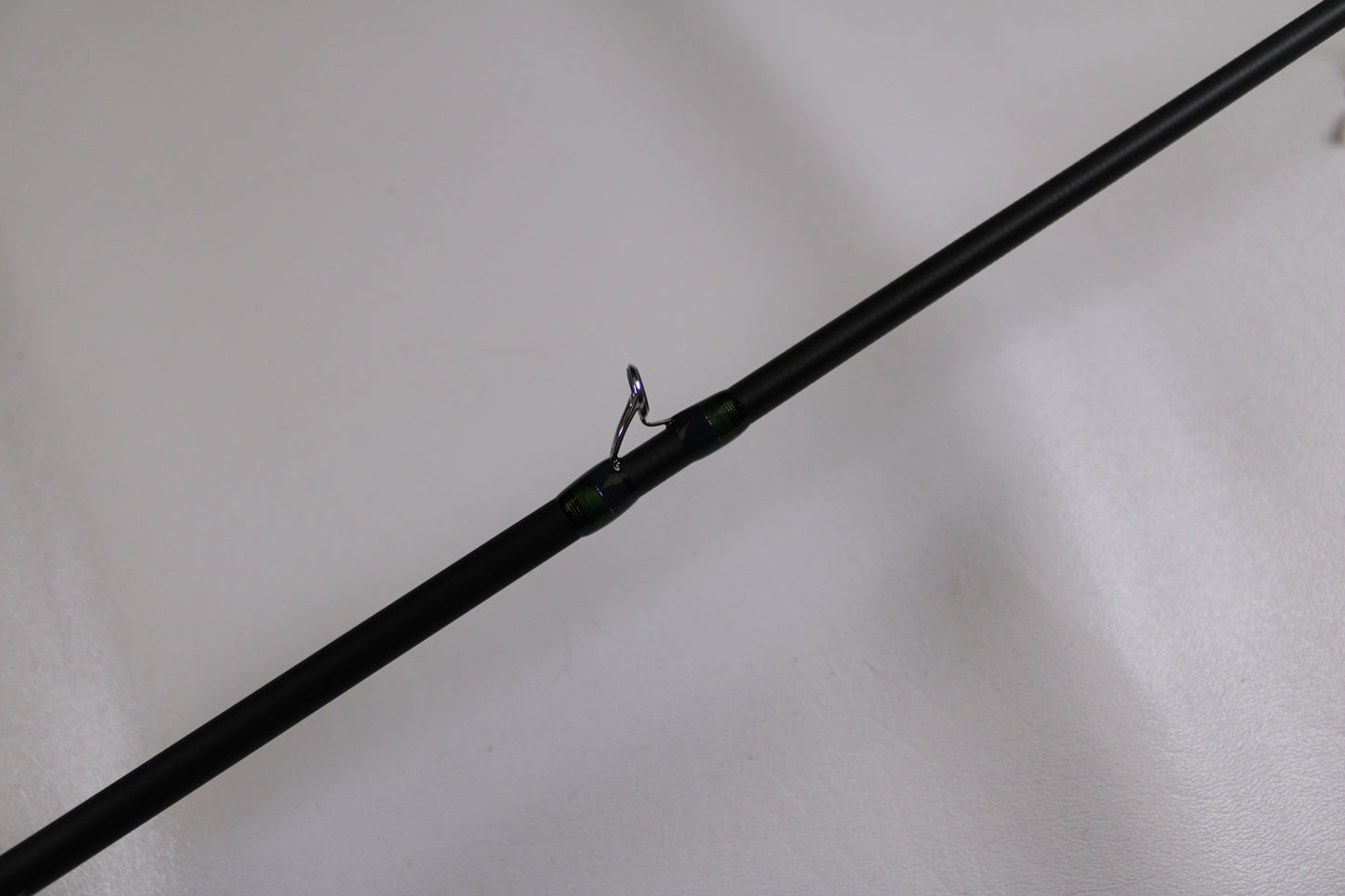 A close-up of the Megabass Orochi X10 F1.1/2-65XT Cliffhanger Used Casting Rod in excellent condition, highlighting a metal line guide—ideal for anglers looking to upgrade or trade in used Megabass gear for store credit.