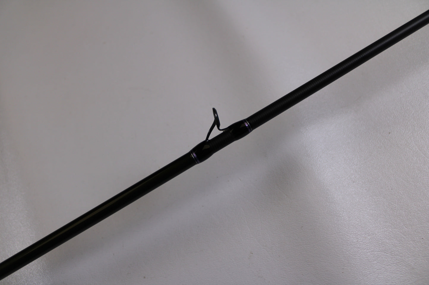 A close-up of the Megabass Levante F3-66LV Used Casting Rod in excellent condition, showing a line guide against a light background—ideal for those interested in used Megabass gear for a Rod and Reel Trade-In Program.