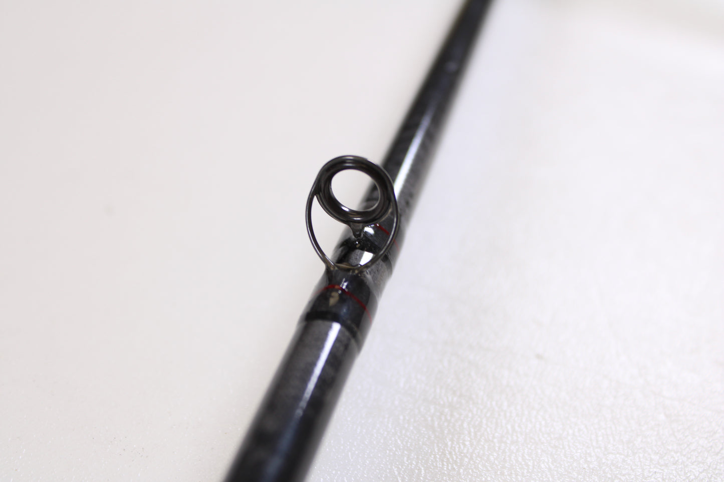 Close-up of a St. Croix Victory VTC68MXF The Jerk 6'8" Medium used casting rod in very good condition, black finish with a guide ring—ideal for those seeking quality pre-owned gear from St. Croix.