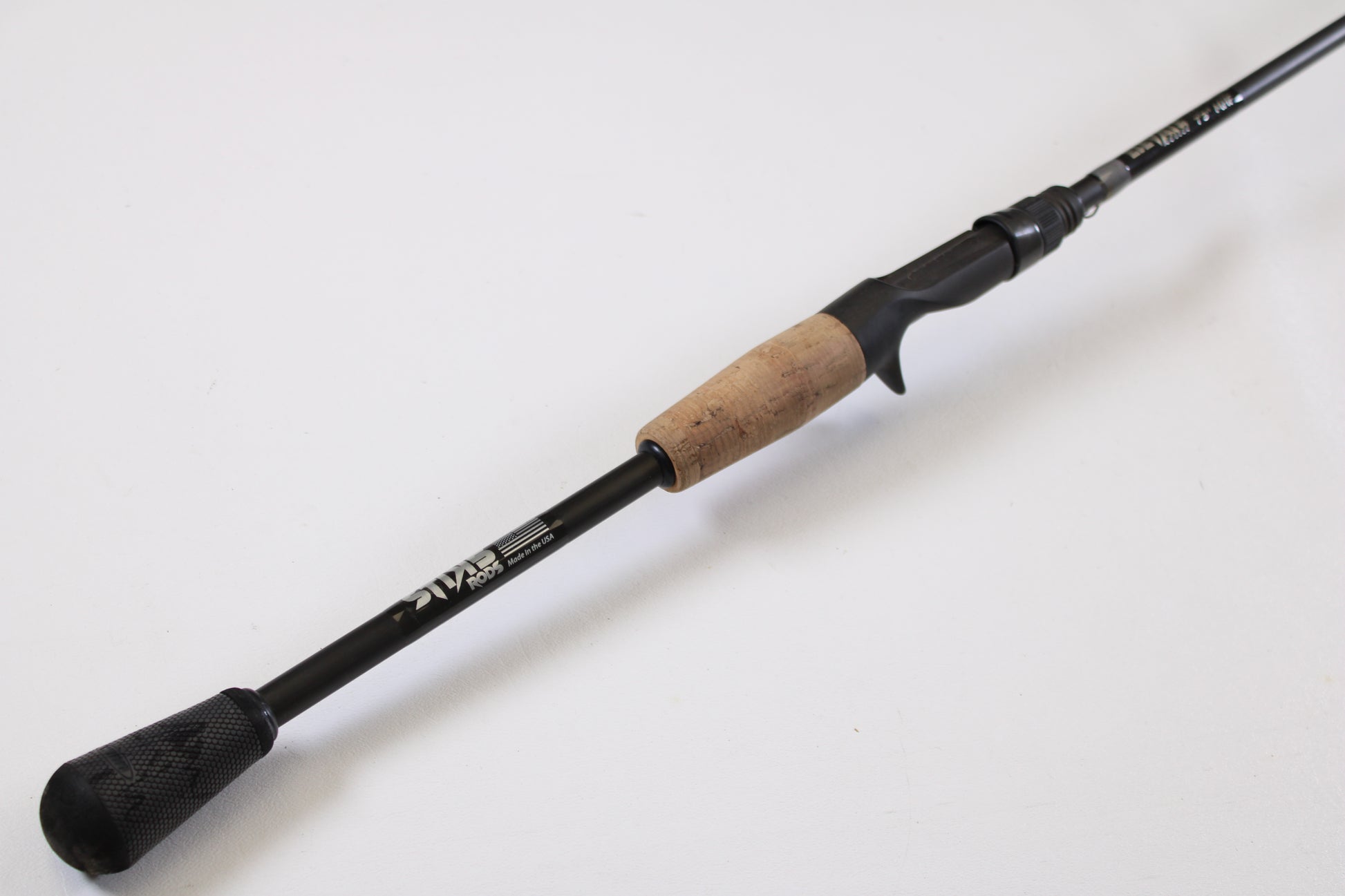A Stik5 Elevate Series The One 7'3" Medium Heavy used casting rod in excellent condition is displayed diagonally on a white background—ideal for upgrading through our rod and reel trade-in program.