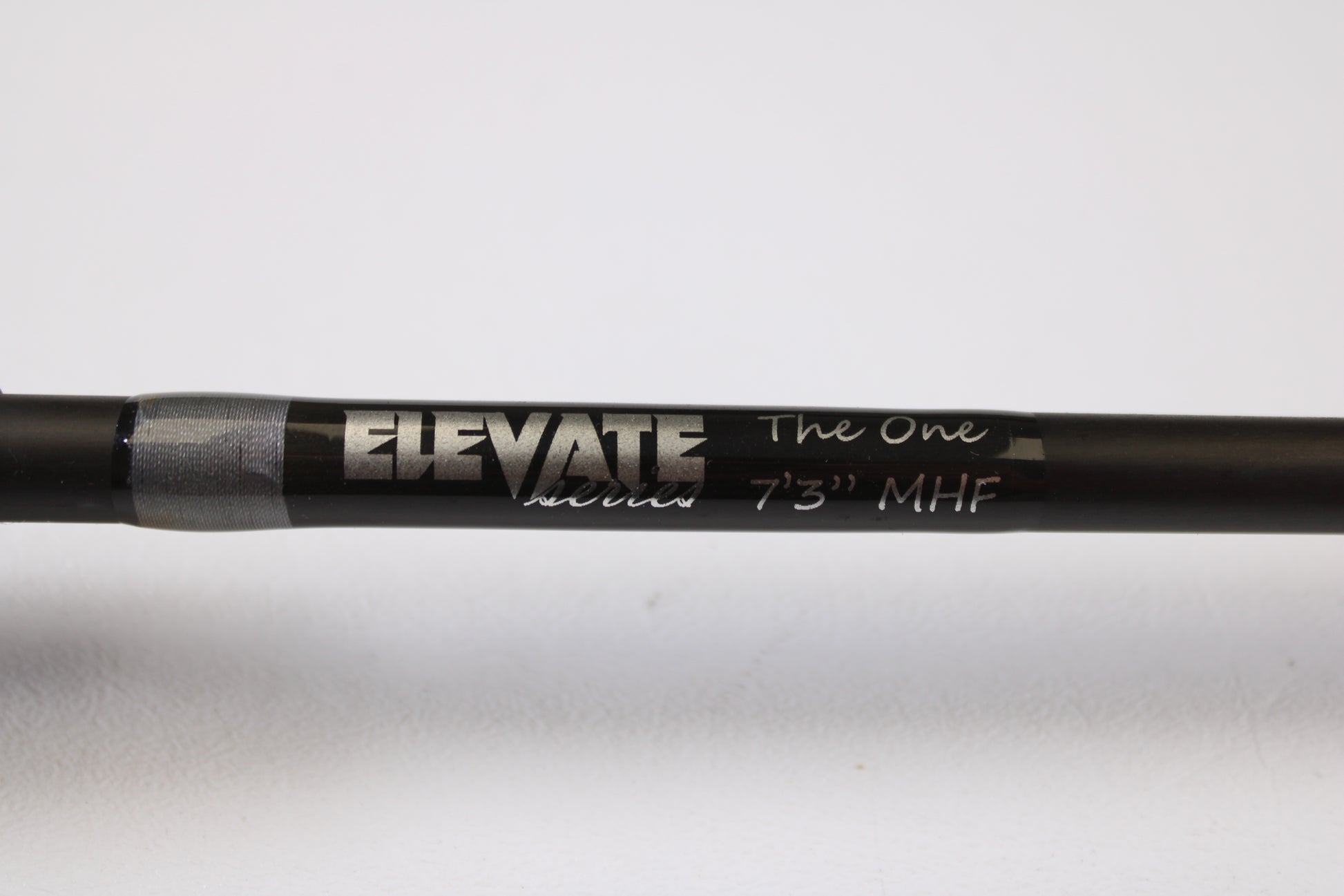 A close-up of a Stik5 Elevate Series The One 7'3" Medium Heavy used casting rod in excellent condition with silver and white text, perfect for upgrading via our rod and reel trade-in program.