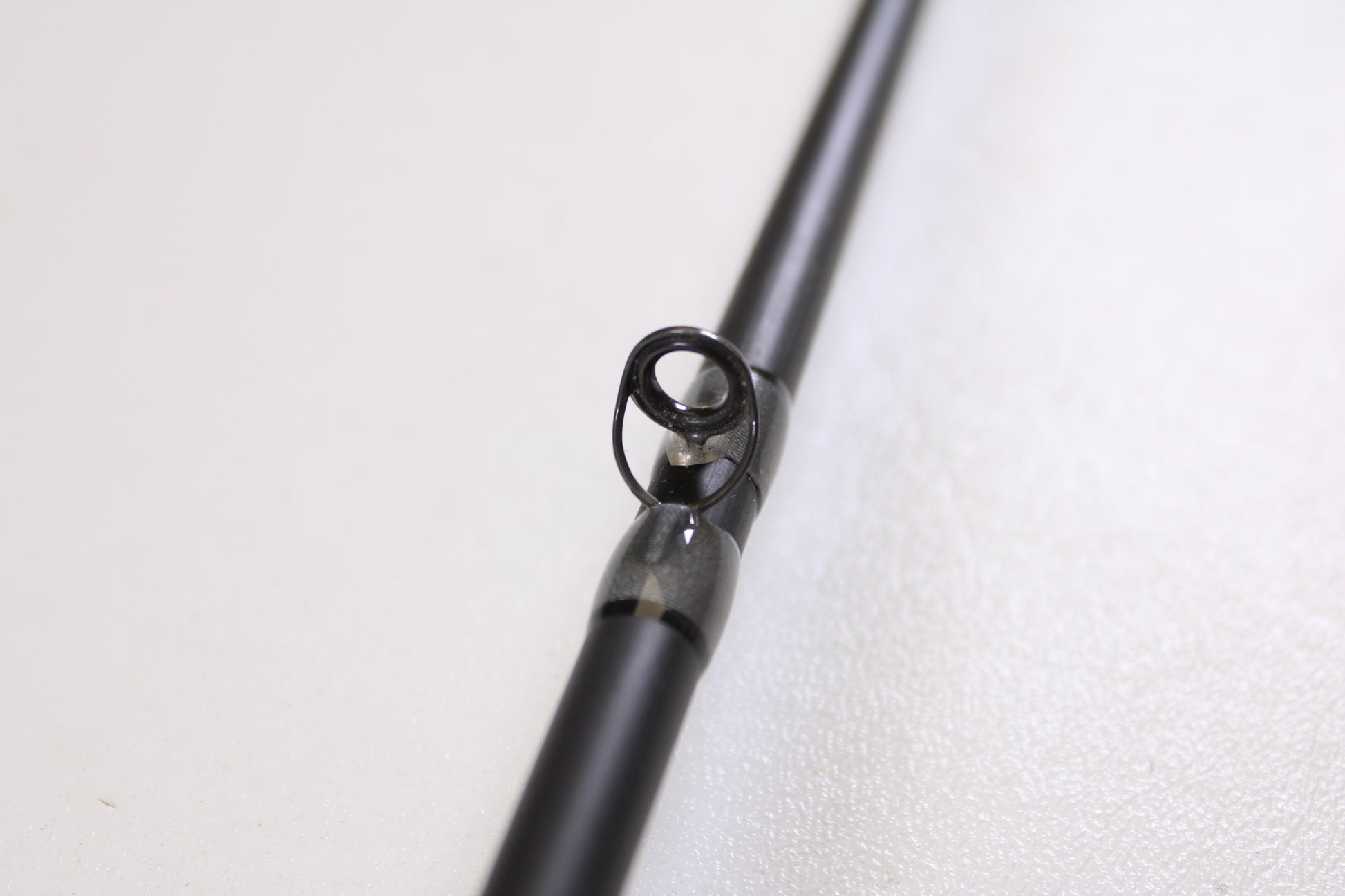 Close-up of the guide ring on the Stik5 Elevate Series The One 7'3" Medium Heavy Used Casting Rod in excellent condition—ideal for anglers seeking top-quality pre-owned gear from Stik5.