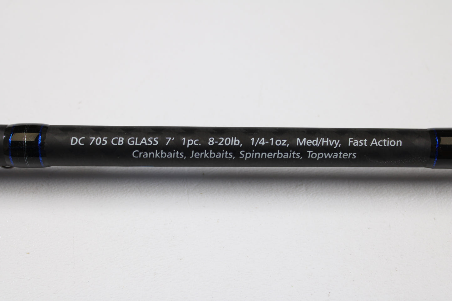 A close-up of the Dobyns Champion XP DC705CBGLASS 7'0" Medium Heavy Glass Casting Rod (Used, Excellent Condition) shows specs in white on black—trade up with our Rod and Reel Trade-In Program for store credit on your next Dobyns purchase.